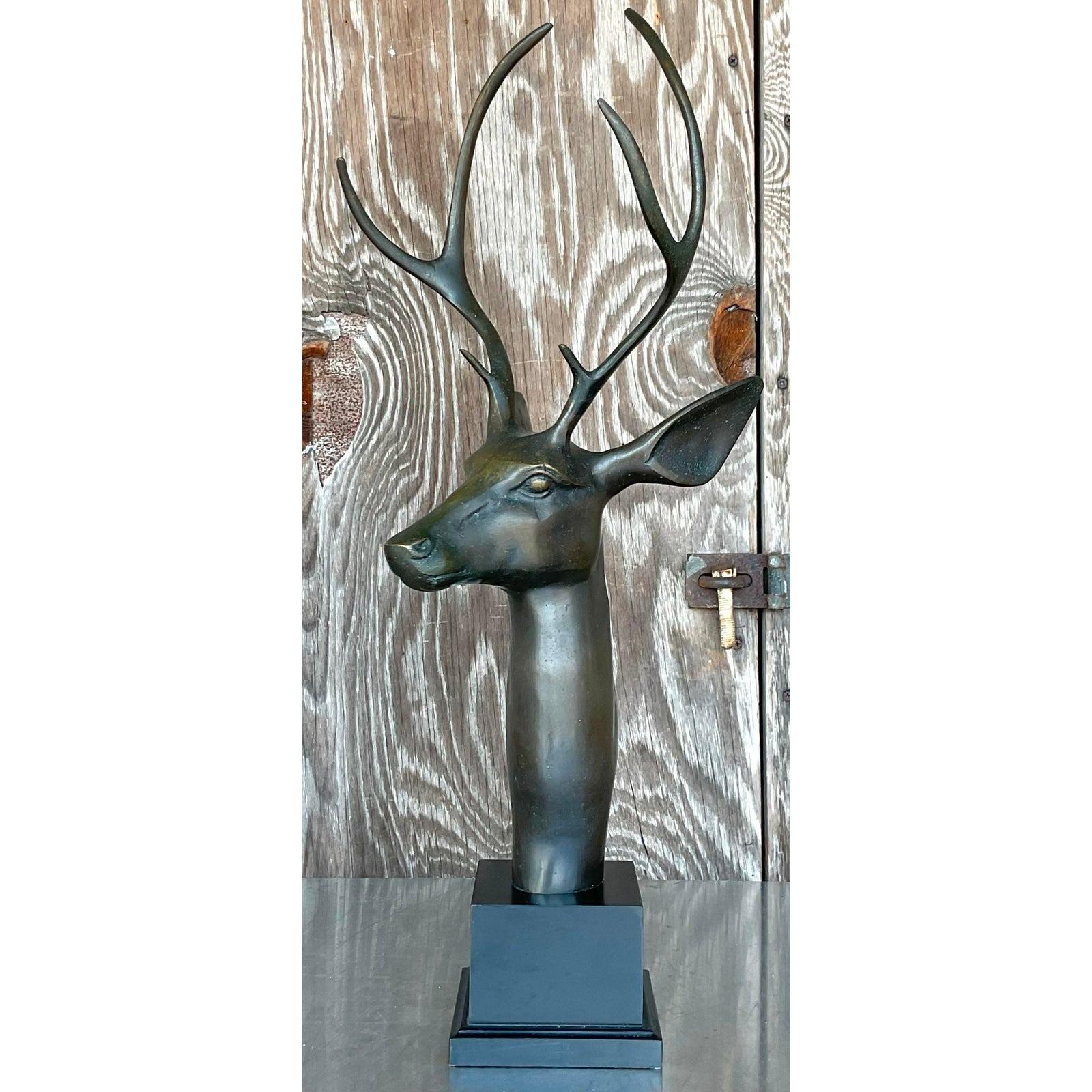 A stunning vintage Boho sculpture in bronze. A chic and commanding six point stag on a wooden plinth. Acquired from a Palm Beach estate.
