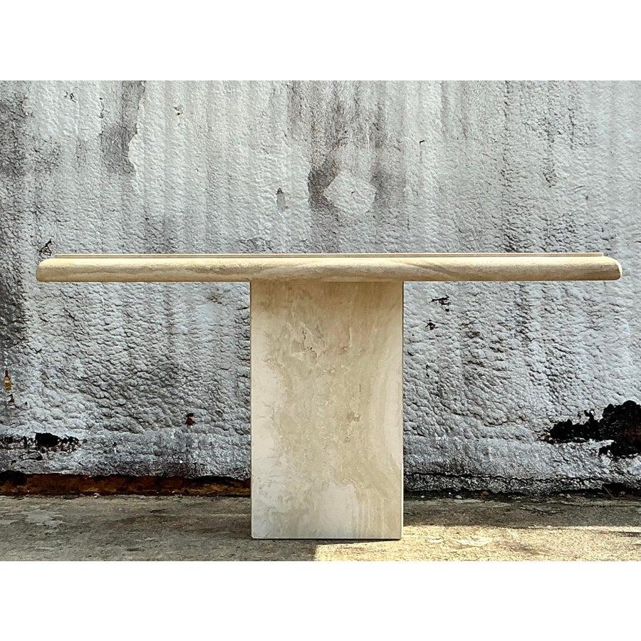 Bring natural elegance to your space with this vintage boho bullnose travertine console table. Crafted from solid travertine, it features a smooth bullnose edge and warm, earthy tones that complement a variety of décor styles. Its minimalist design