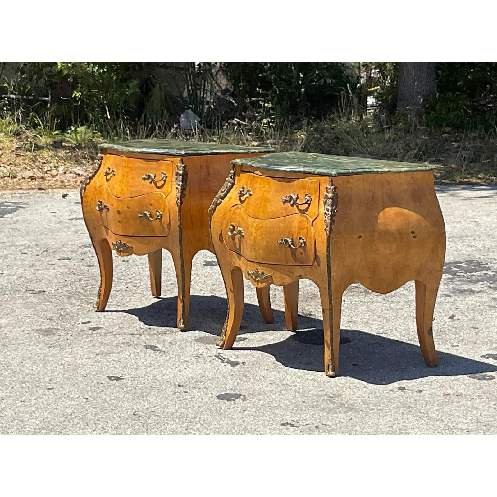 A stunning pair of vintage Boho Bombe chests. Gorgeous Burl wood cabinets with incredible wood grain detail. Green marble tops and brass Ormolu hardware. Perfect as chest, but also gorgeous as nightstands. Acquired from a Palm Beach estate.