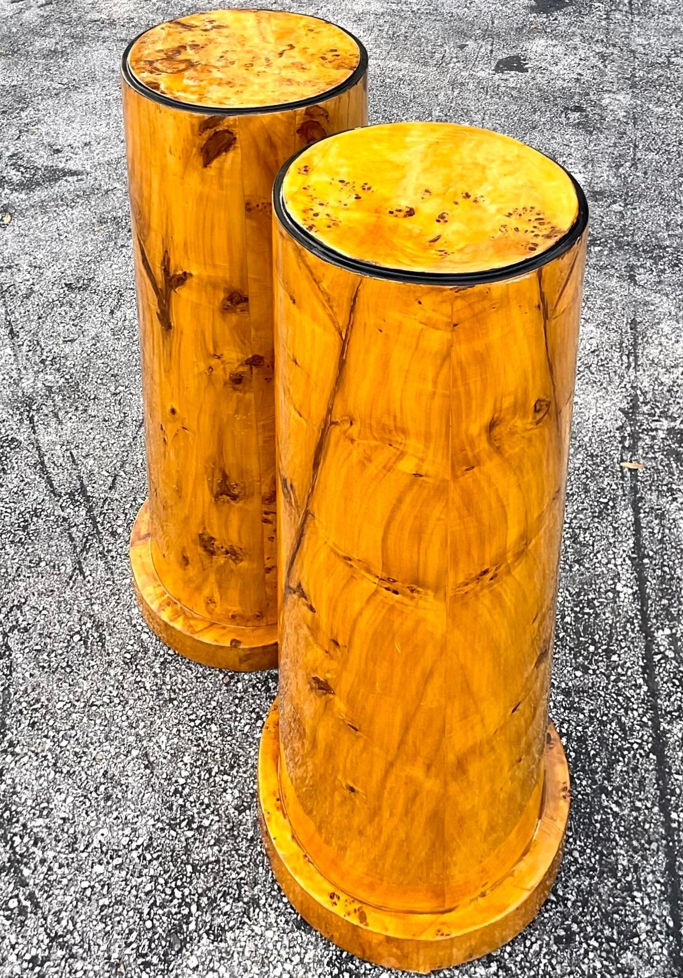 A stunning pair of vintage Boho pedestals. A chic Burl wood construction in a classic cylinder shape. Beautiful high gloss lacquered finish. Acquired from a Palm Beach estate.
