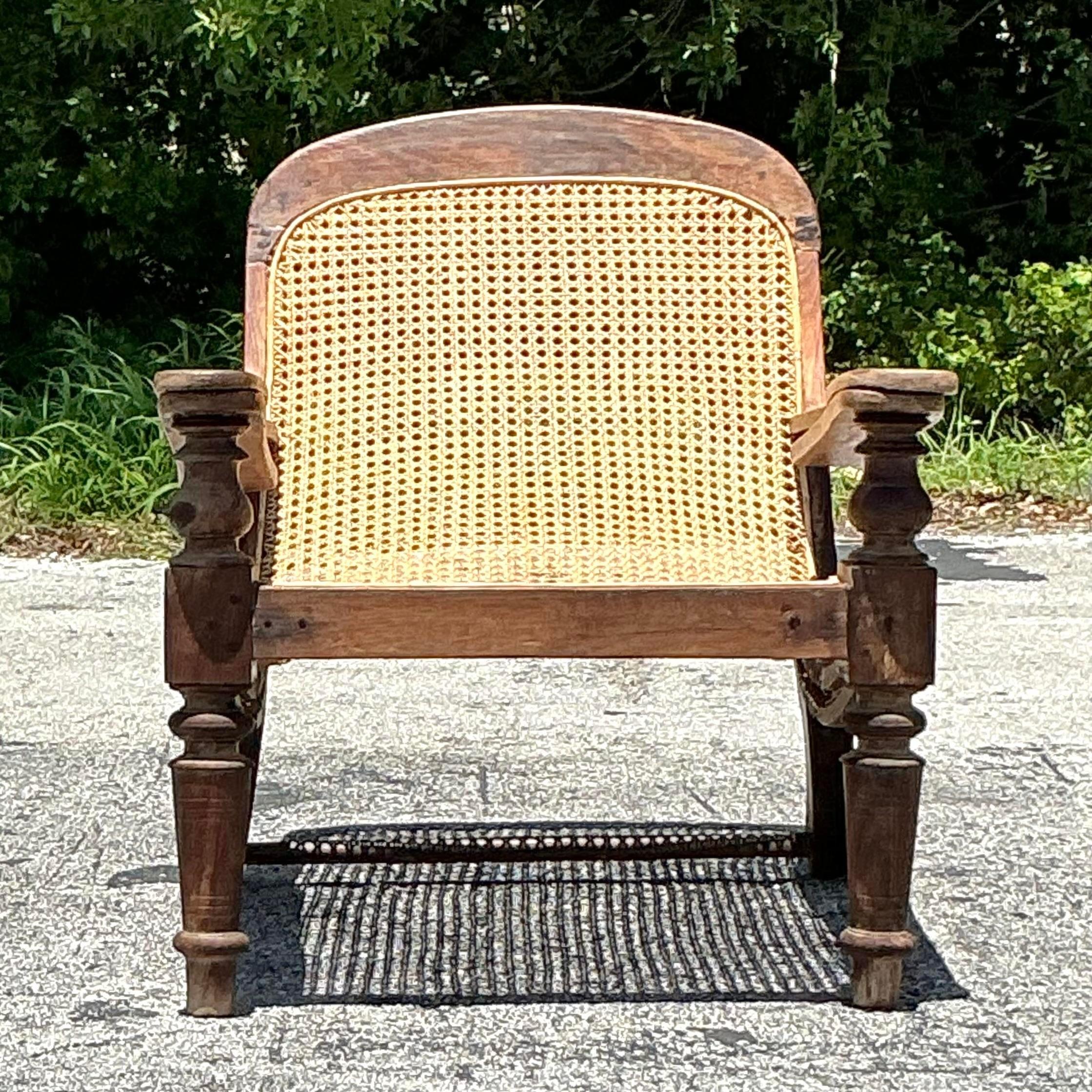 Relax in style with our American-style Vintage Boho Cane Plantation Chair. Featuring intricately woven cane and bohemian design elements, this chair combines vintage charm with comfortable elegance, making it a perfect addition to any living space.