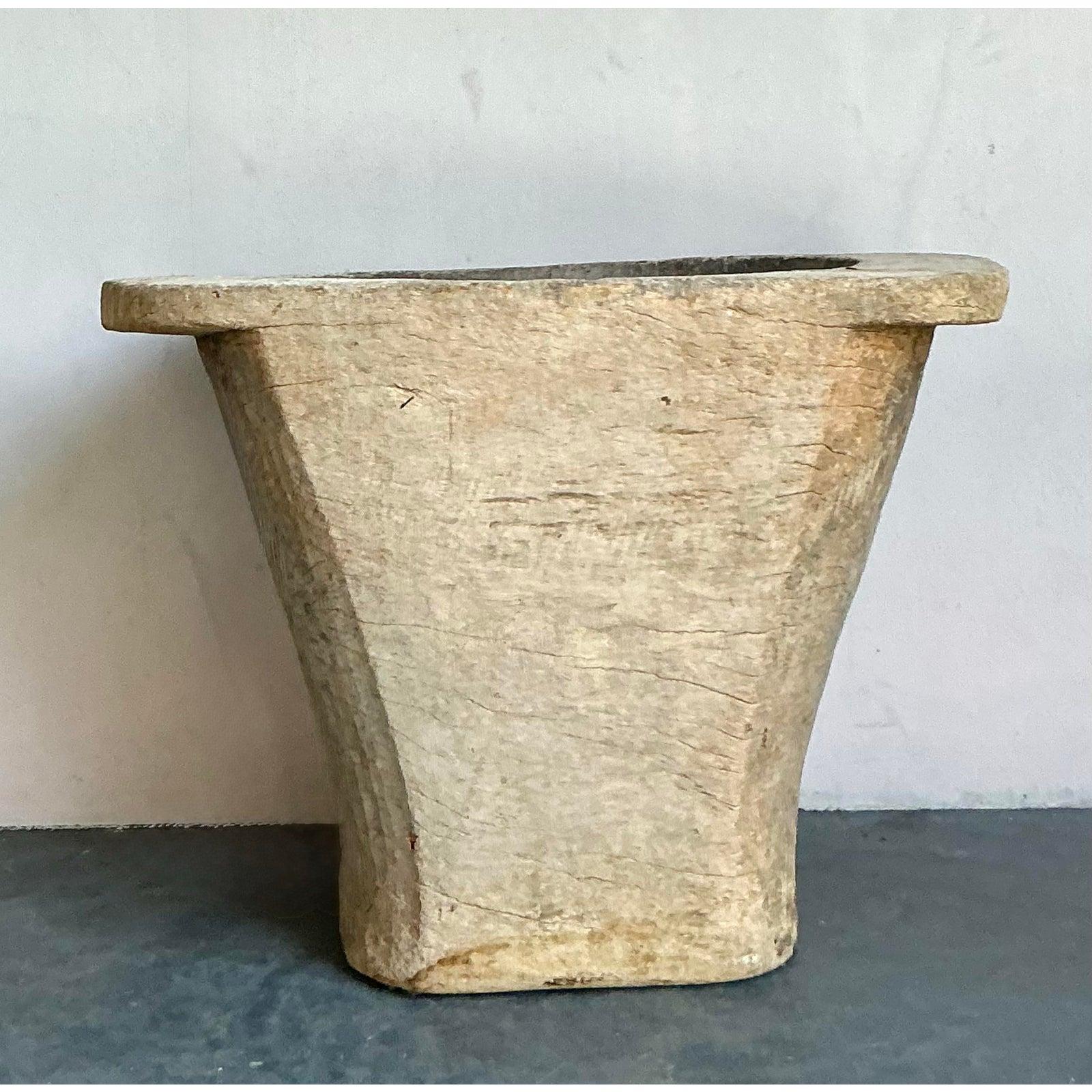 Embrace the raw, sculptural beauty of the natural world with this monumental vintage planter. Hand-carved from what is believed to be a single, solid coconut trunk, this incredible vessel is a masterpiece of primitive artistry. Its deeply weathered