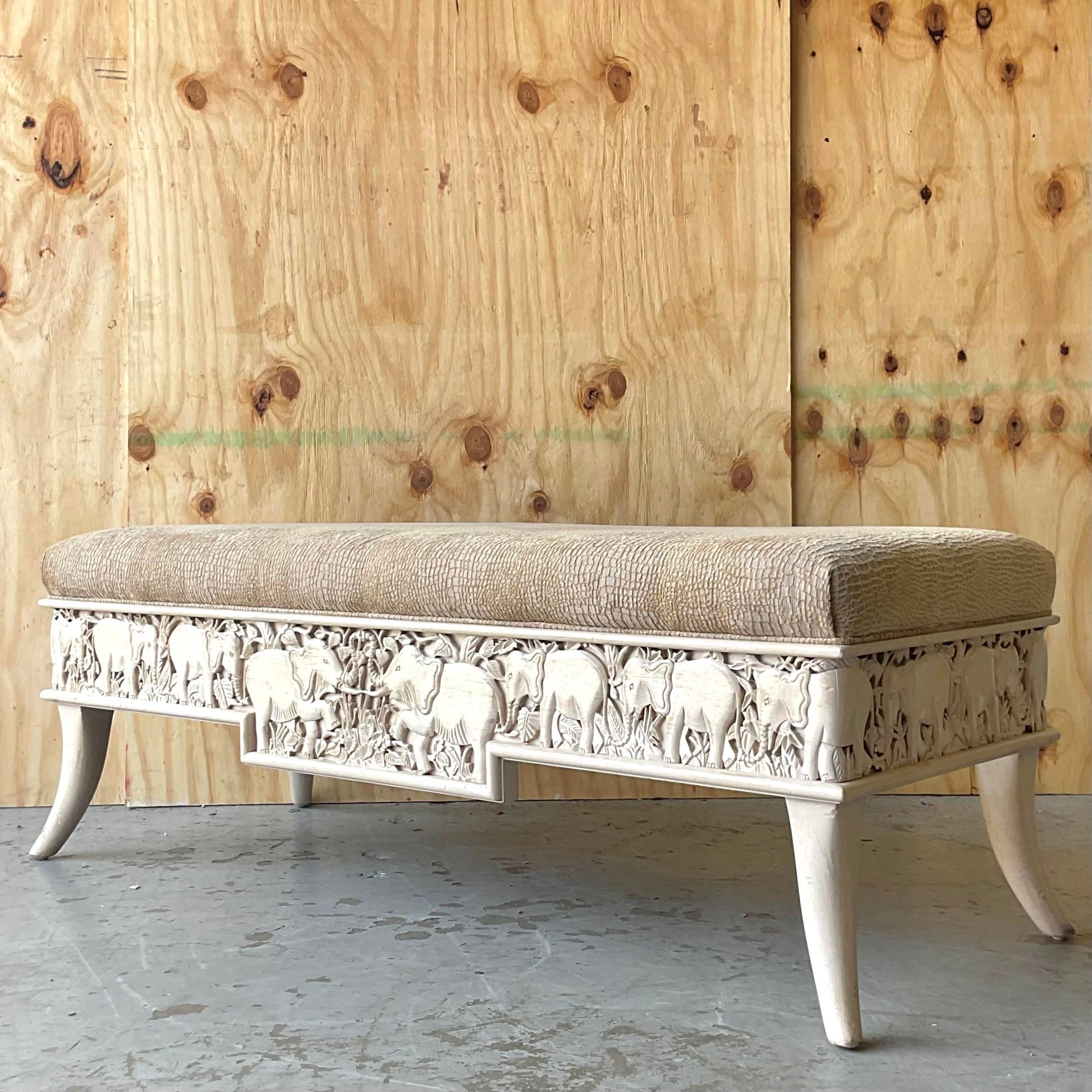 A fabulous vintage Boho bench. A chic carved band of elephants wraps around the frame. Faux elephant velvet upholstery. Acquired from a Palm Beach estate. 