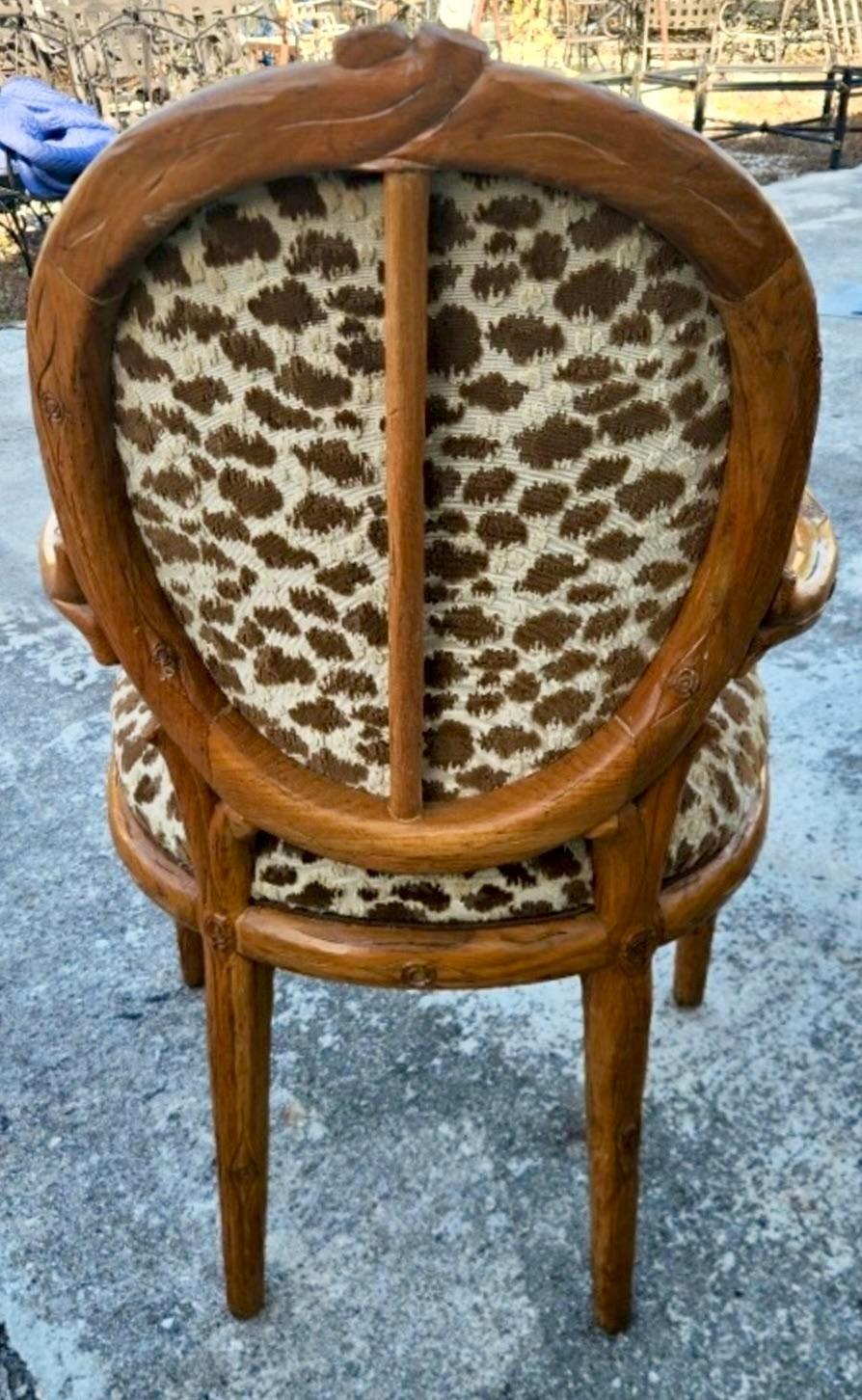 A stunning pair of vintage Boho arm chairs. A chic hand carved Faux Bois design with a beautiful patina from time. A gorgeous silk Devore leopard upholstery. Acquired from a Palm Beach estate.