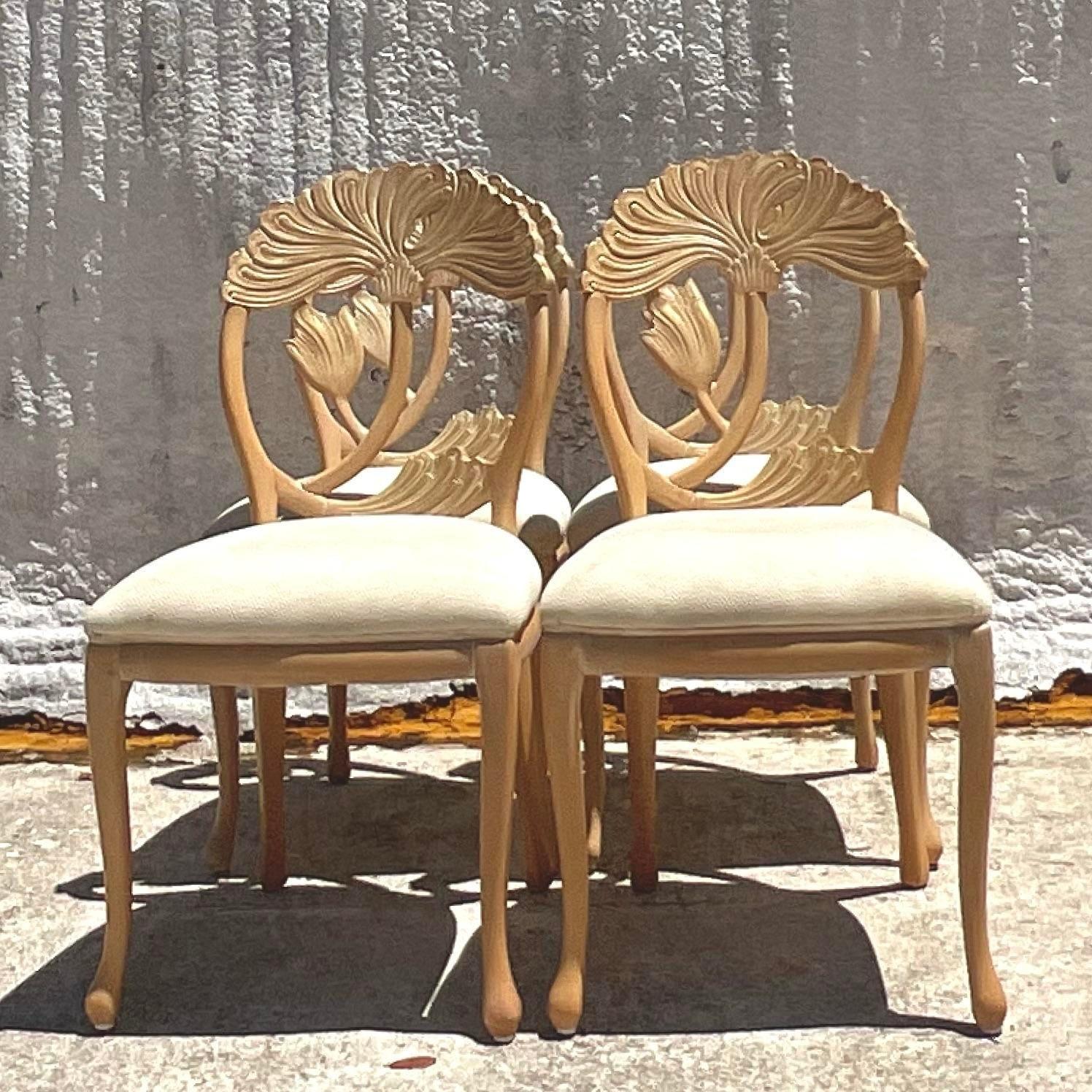 A fabulous set of four vintage Boho dining chairs. Chic carved lotus blossom in a pale ash color. Acquired from a Palm. Each estate
