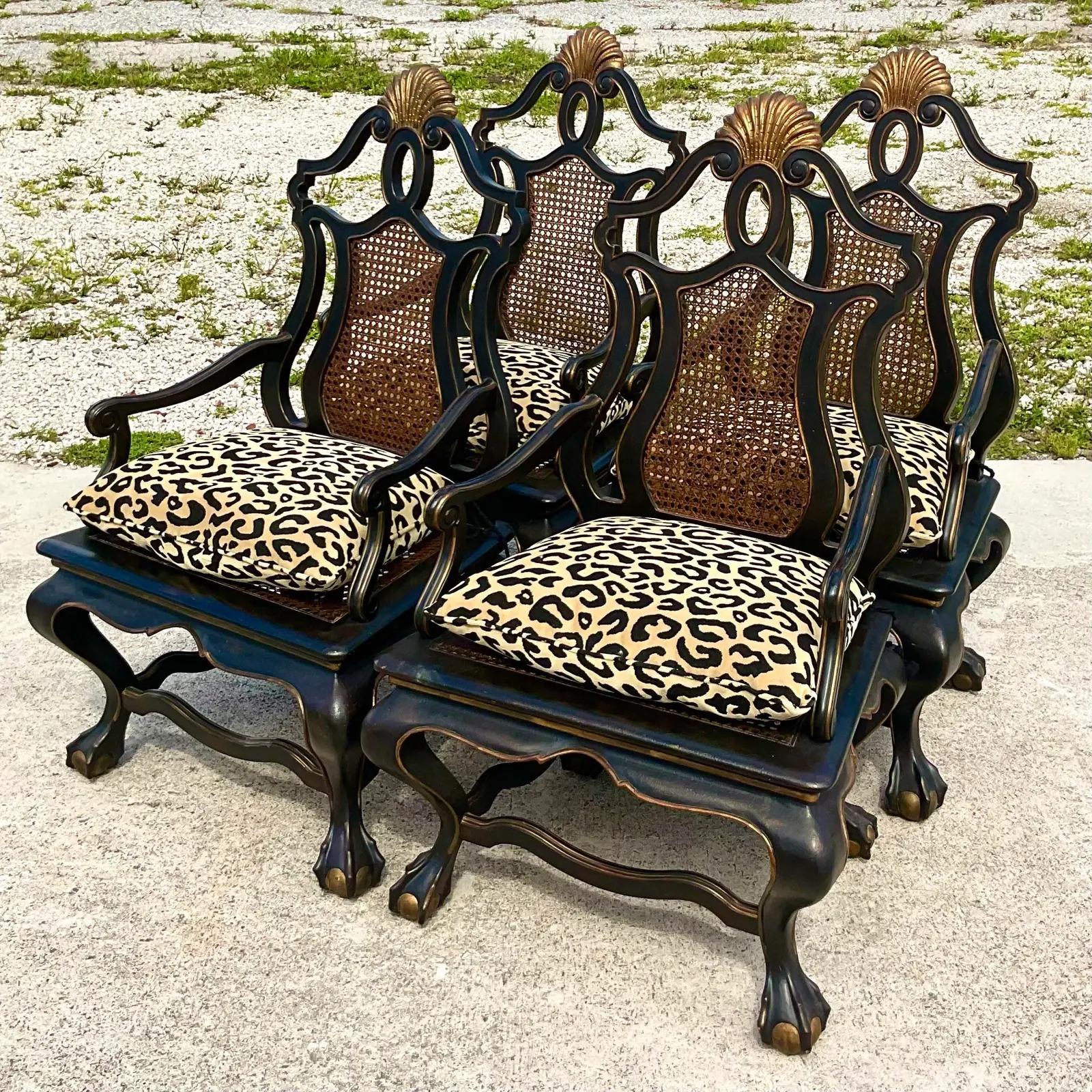 Incredible set of four monumental cane chairs. Monumental in size and drama. Over scaled with black lacquer finish and gilt tipping detail. Inset cane seat and back. Loose velvet leopard seat chariots with tassel ties. Acquired from a Palm Beach