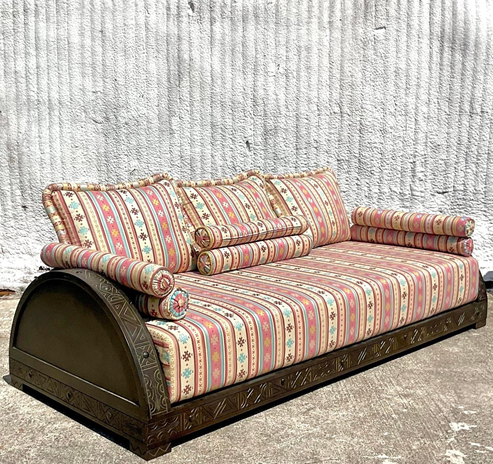 Add a touch of exotic elegance to your home with this Vintage Boho Carved Moroccan Sofa. Featuring intricate hand-carved details and luxurious upholstery, this unique piece brings a vibrant, bohemian flair to any living space. Perfect for creating a