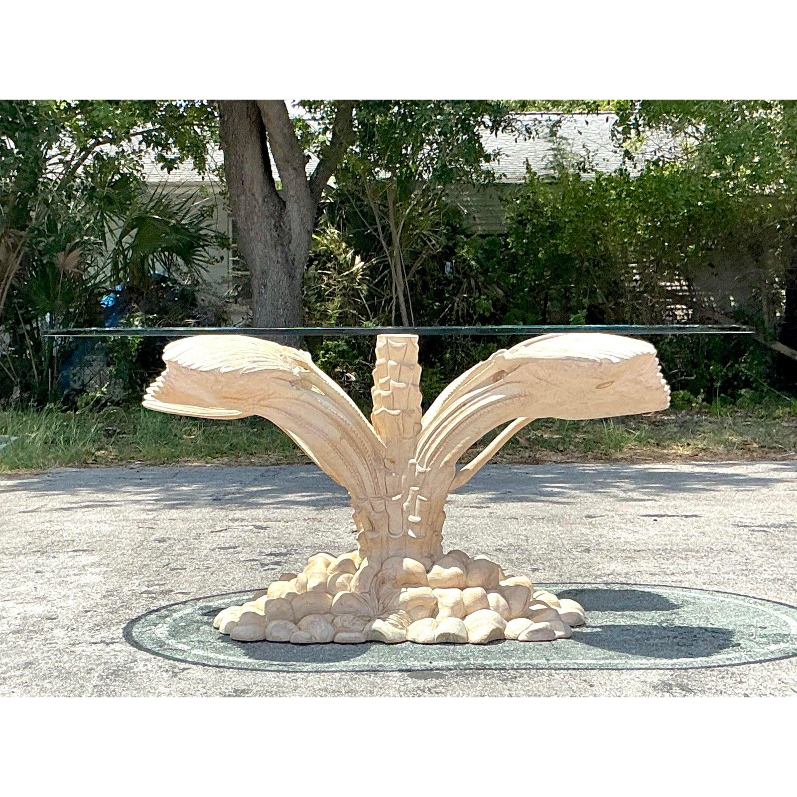 Bring a breezy, tropical elegance to your interiors with this stunning Vintage Boho Carved Palm Tree Dining Table. Expertly crafted with exquisite attention to detail, this table features a charming carved palm tree motif, adding whimsical texture