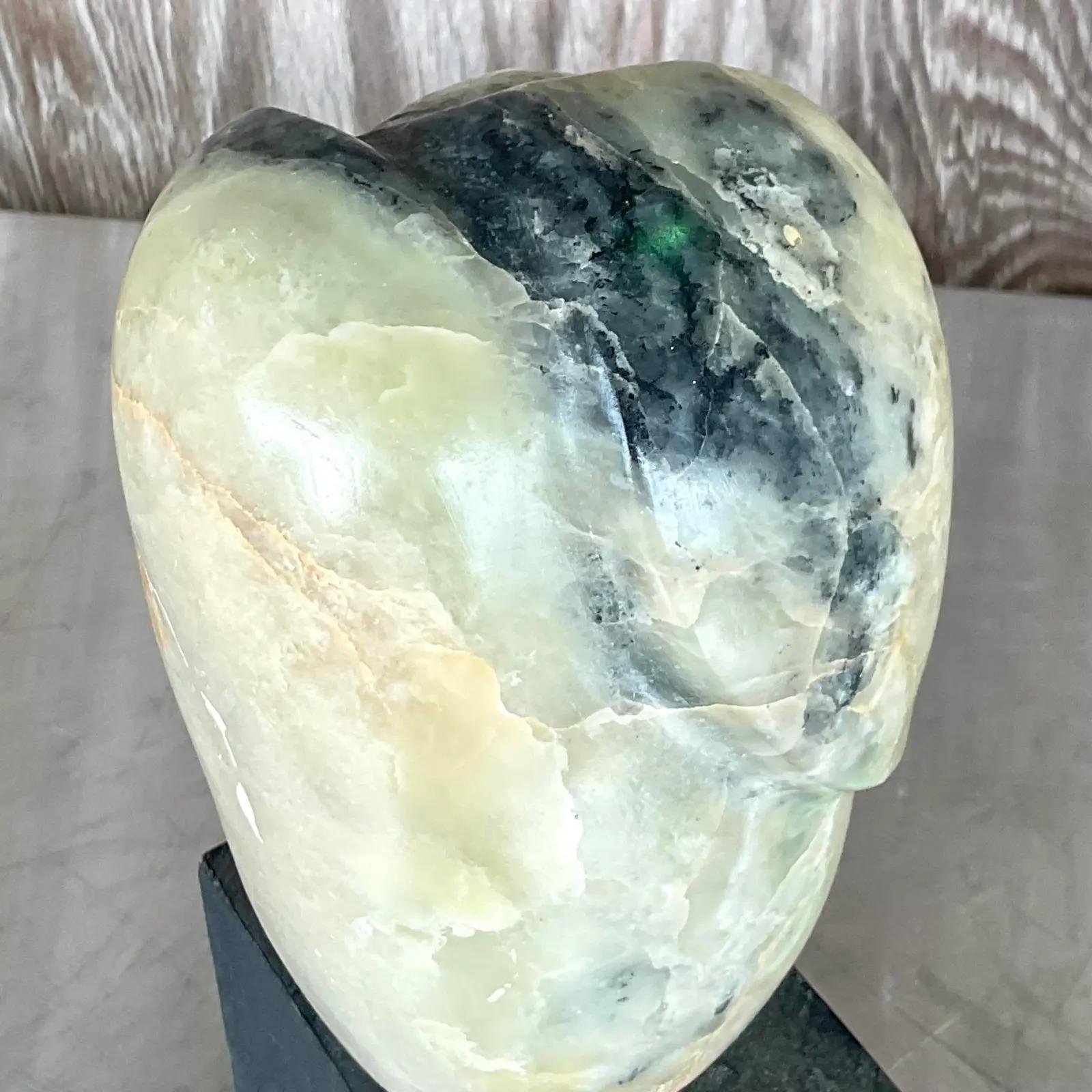 Fantastic vintage Boho sculpture. Beautiful hand carved stone in striking pale greens and black. Rests on a black painted wood block. Acquired from a Palm Beach estate.