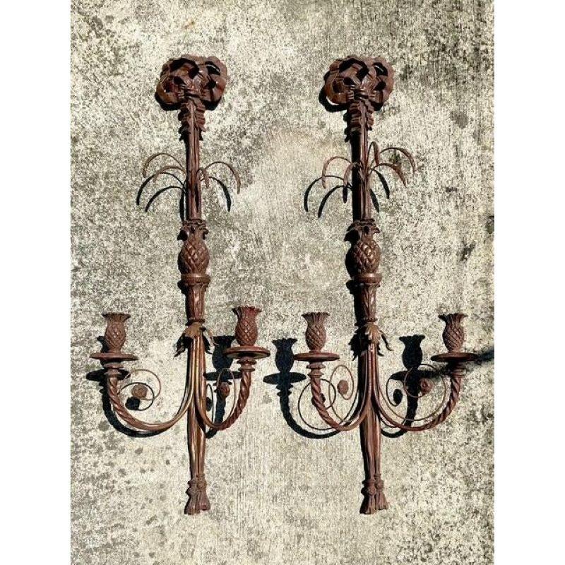 Add striking, sculptural elegance to your walls with this dramatic pair of Vintage Boho Carved Wood Candle Sconces. Towering at over three feet tall, these statement sconces feature rich detailing with pineapples, palm-like fronds, and scrolling
