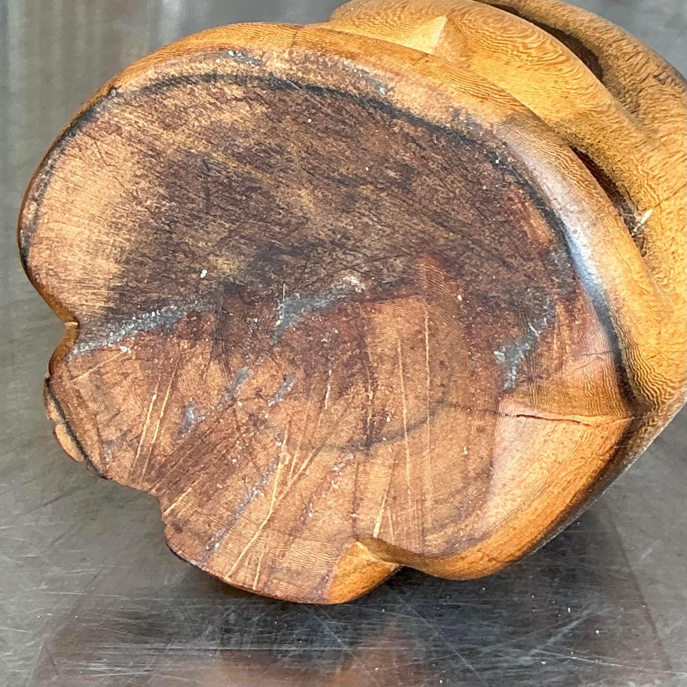 Add a charming and whimsical touch to your space with this vintage carved cat figurine. Handcrafted with intricate detailing, this boho-inspired wooden cat showcases natural wood grain and a stylized design that emphasizes its curious and playful