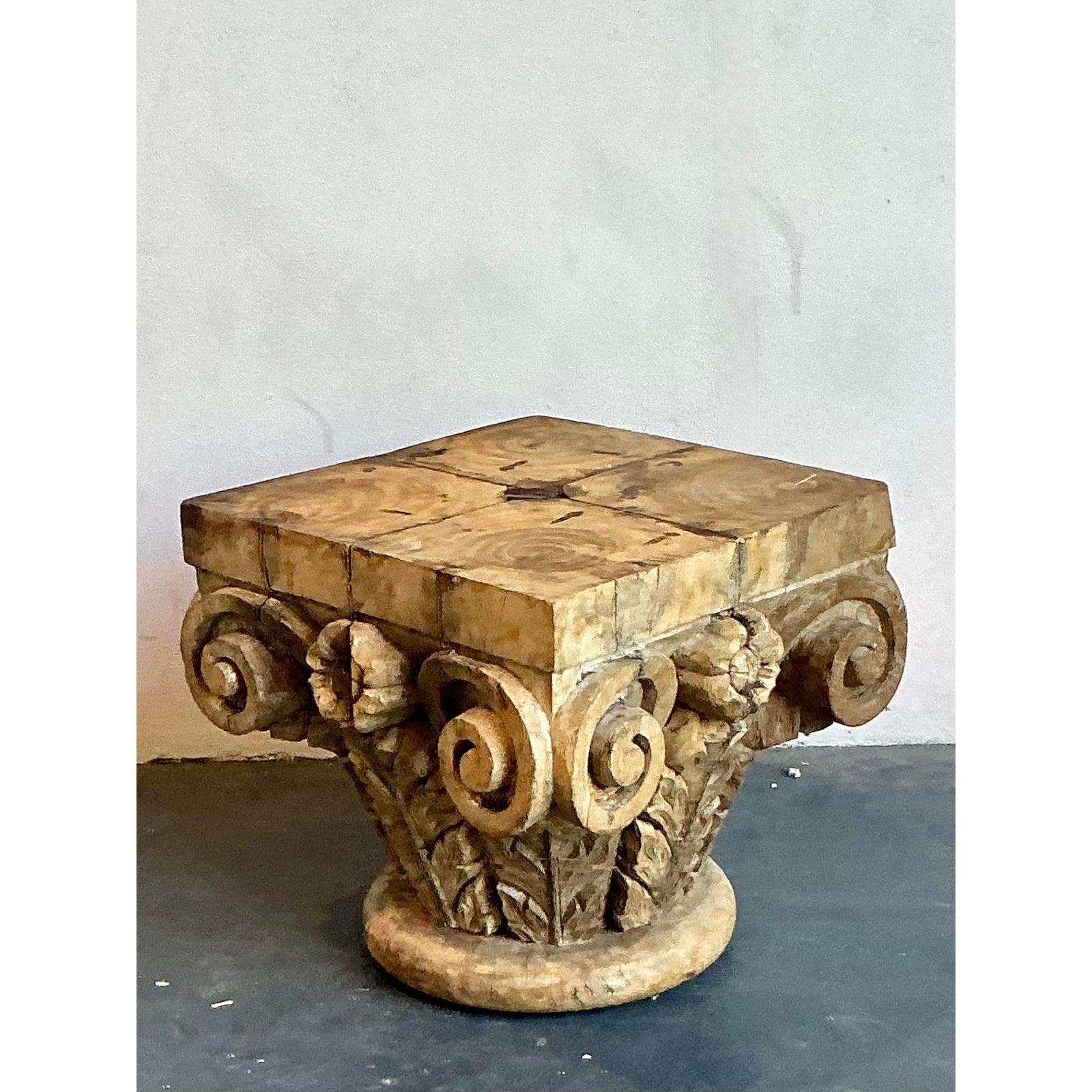 Introduce a layer of architectural history and rustic character into your home with this captivating pair of carved wood tables. This set features two distinct column fragments—one a classical Corinthian-style capital and the other a sturdy column