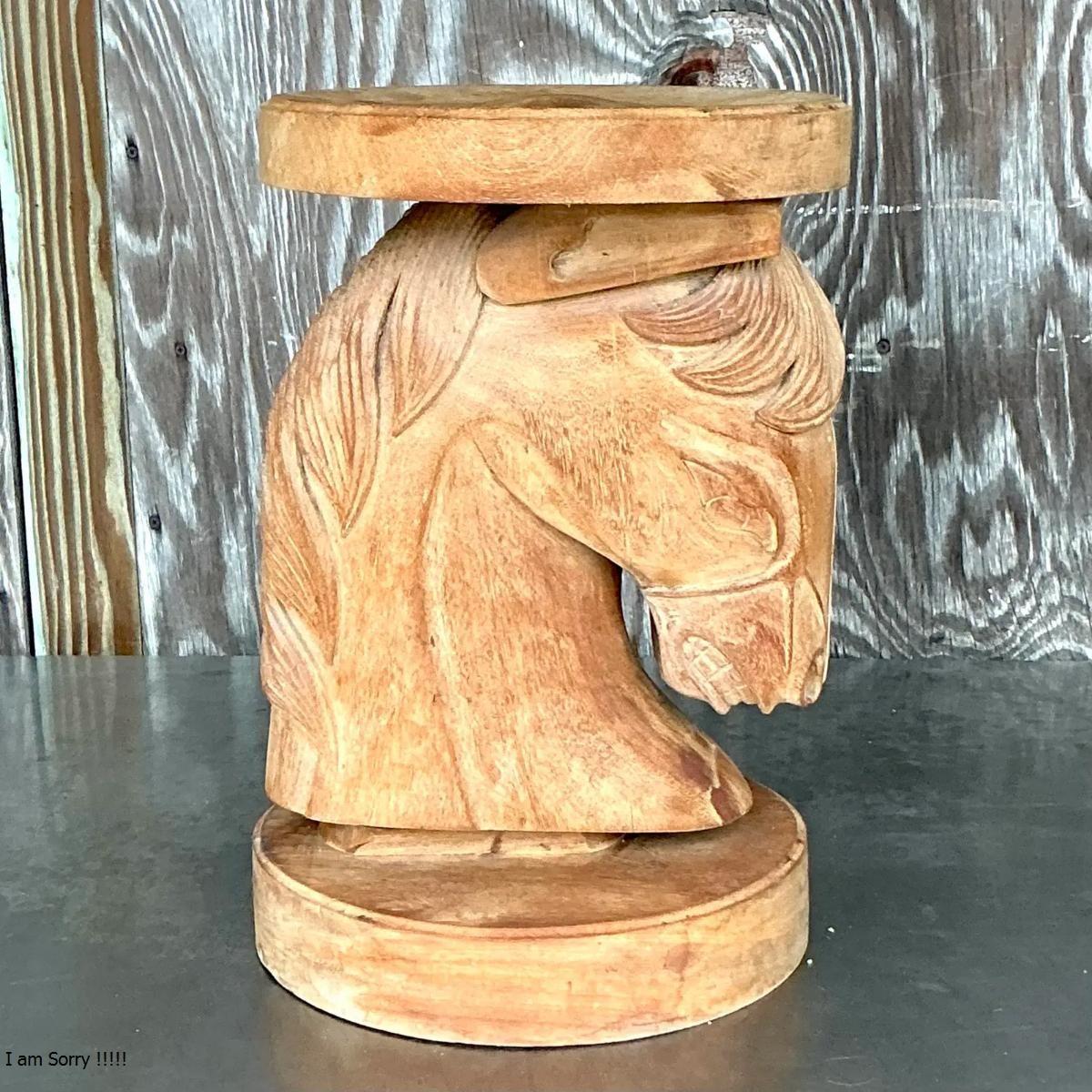 Elevate your boho décor with this unique vintage carved wood stool featuring a striking horse head design. Crafted from natural wood, this low stool showcases intricate detailing in the horse's mane, face, and posture, embodying both rustic charm