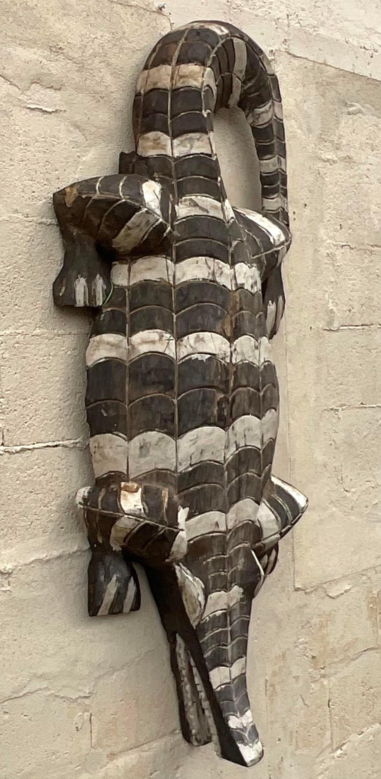 A striking vintage Boho crocodile. A chic hand carved body with monochromatic hand painted finish. Great on the floor or also great as a wall hanging. Two crocodiles available on my page. Acquired from a Palm Beach estate