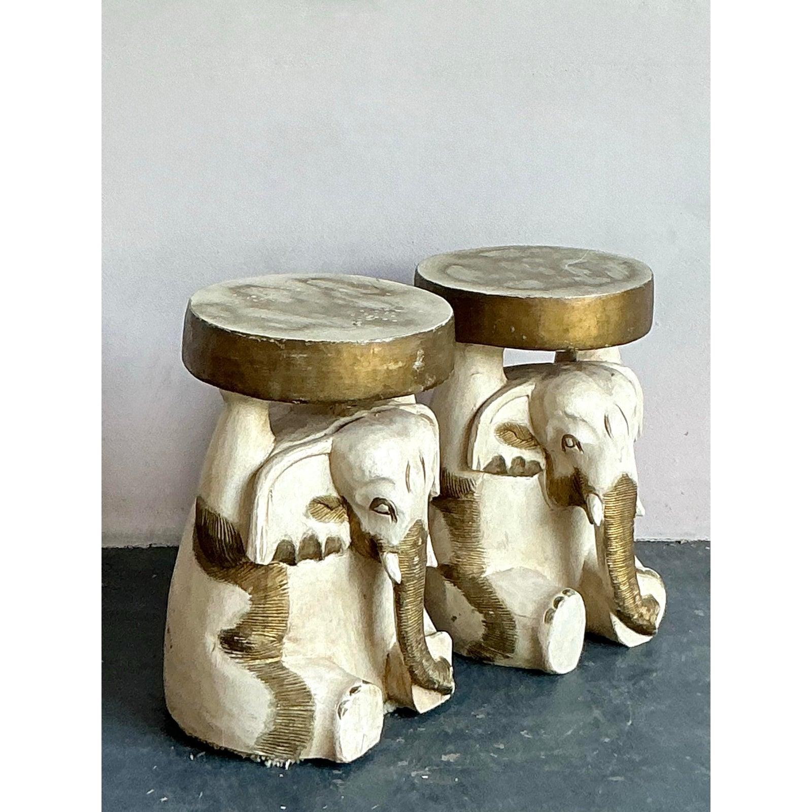 Introduce an exotic touch to your home with this delightful pair of vintage carved wooden elephant low stools. Each stool is a testament to skilled craftsmanship, featuring a beautifully detailed elephant sculpture serving as the base, adorned with