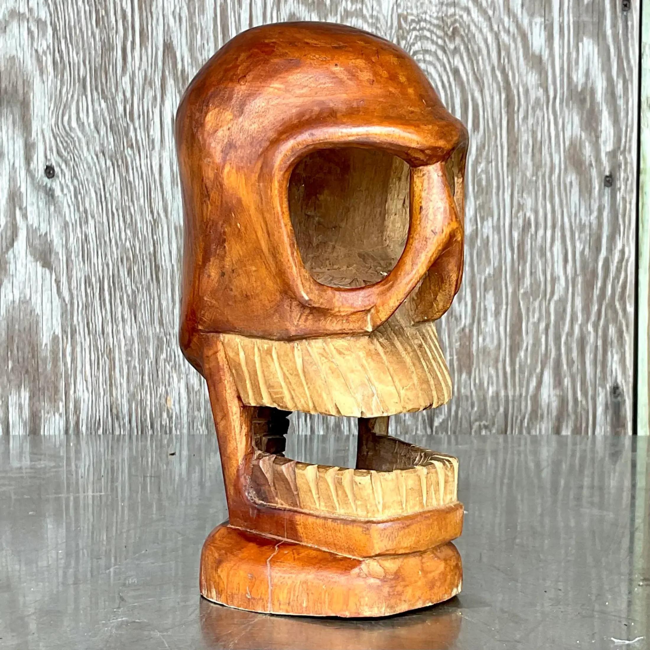 A fantastic vintage Boho carved skull. An abstract composition with beautiful wood grain detail. Acquired from a Palm Beach estate.
