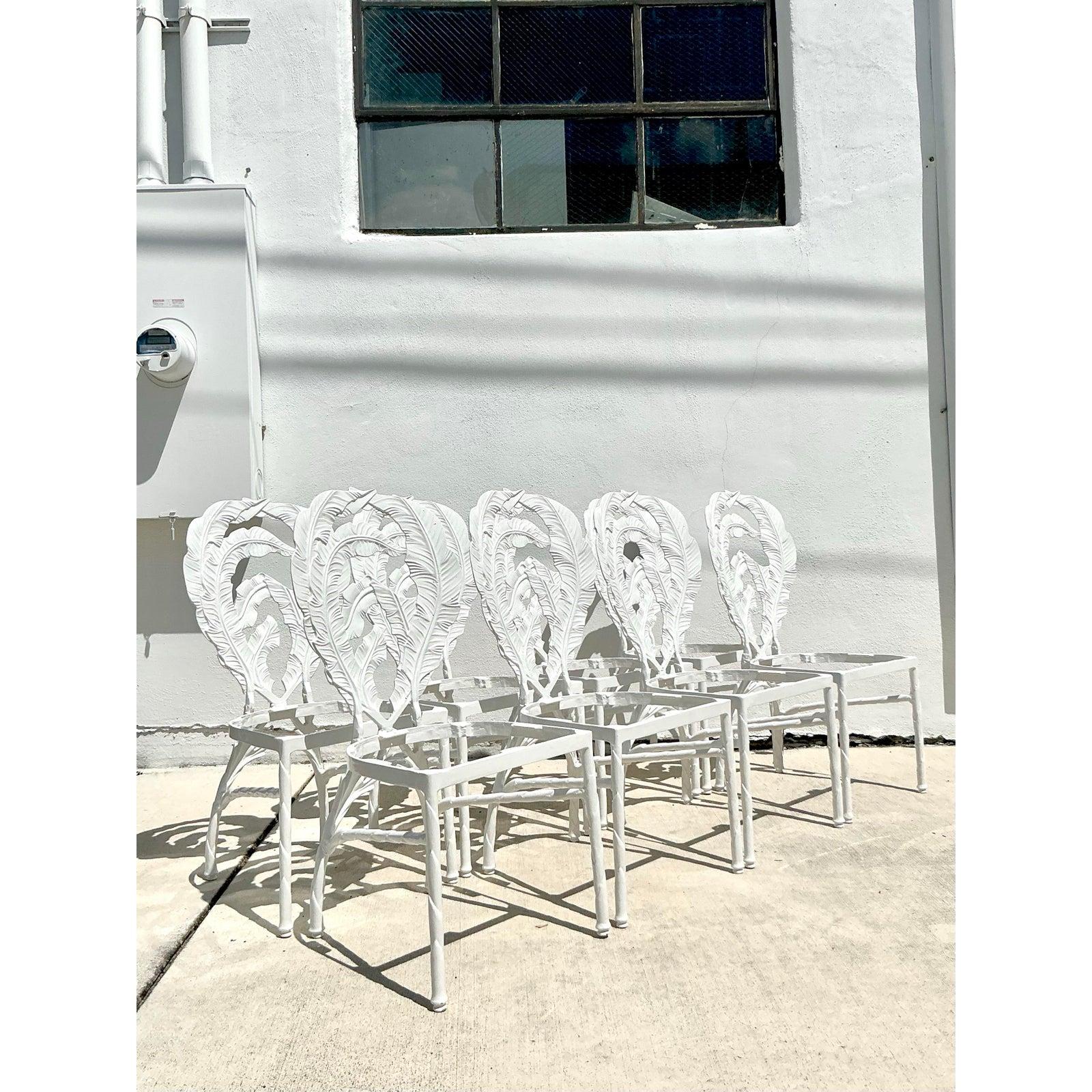 Infuse your dining space with the timeless glamour of Palm Beach with this incredible complete set of eight vintage dining chairs. Each chair is crafted from durable cast aluminum and features a dramatic, sculptural back designed as an oversized,