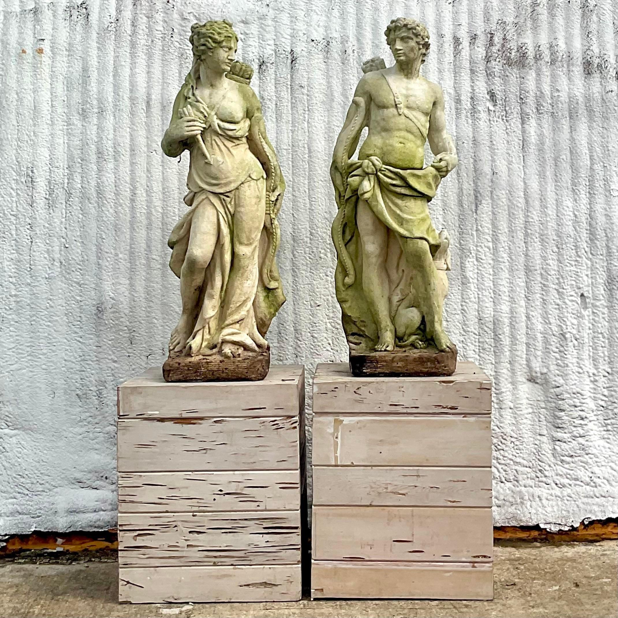 A fabulous pair of vintage Boho outdoor statues. A gorgeous patinated cast concrete depiction of Diana and Actaeon. Thr impressive duo rest on an equally impressive pair of custom Pecky cypress plinths. Acquired from a Palm Beach estate.