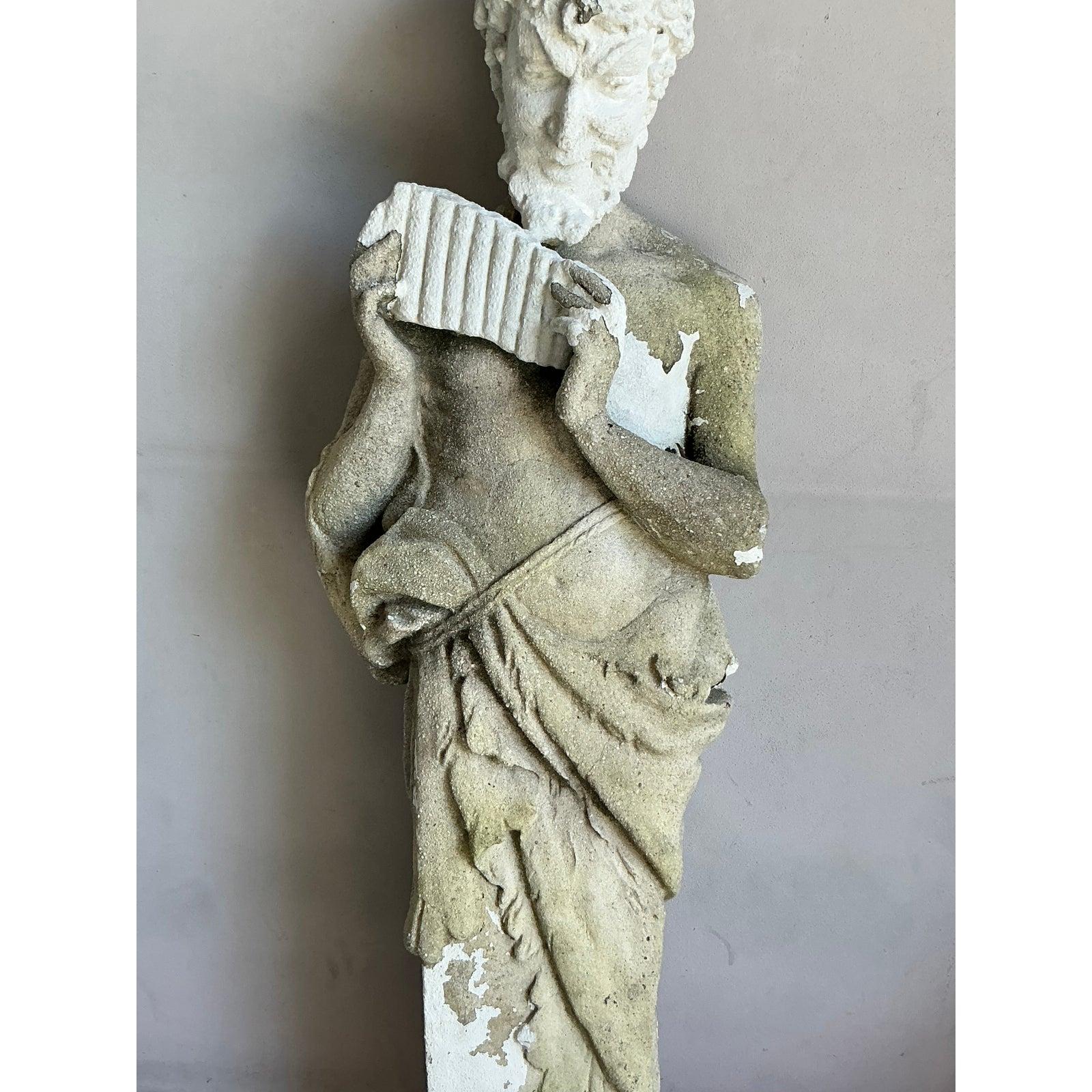 Presenting a captivating vintage cast concrete figure of Pan, a striking garden statue that brings an air of classical mythology and rustic elegance to any outdoor or indoor space. This beautifully weathered sculpture depicts the Greek god Pan,