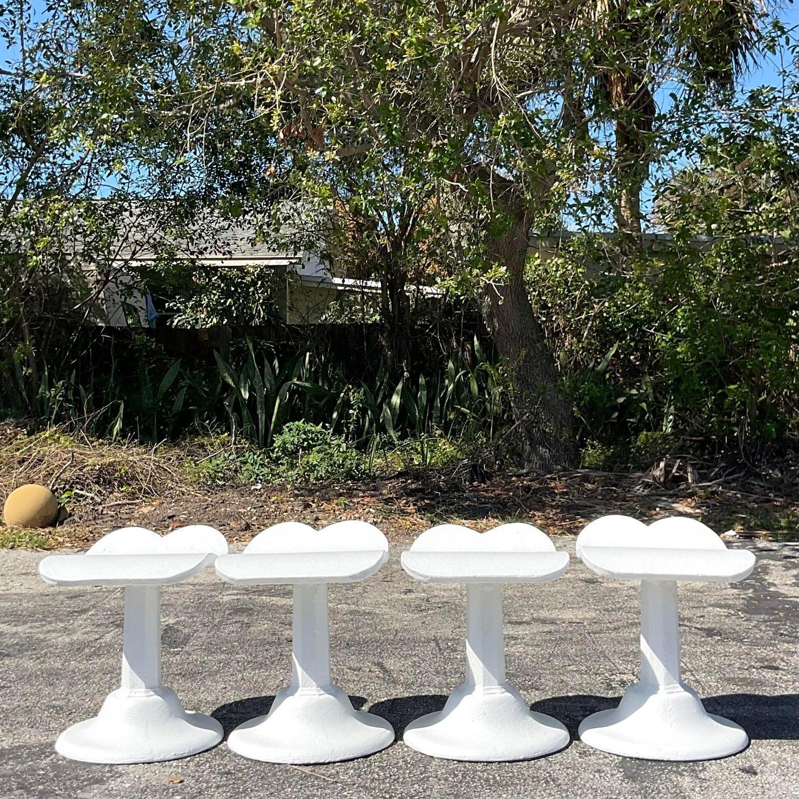A fabulous set of four vintage low stools. Done in the manner of Dorothy Draper. Chic cast concrete in a bright white finish. Acquired from a palm Beach estate.

Seat height 17.5