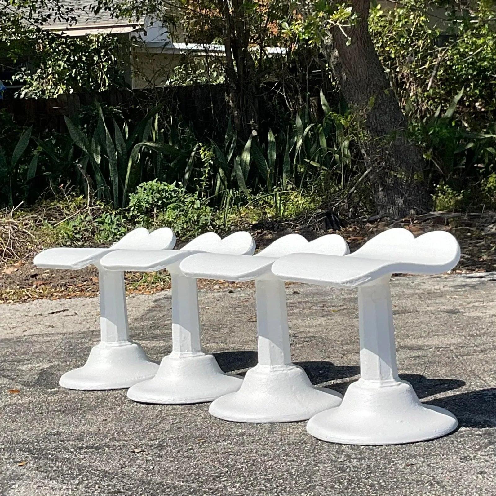 A fabulous set of four vintage low stools. Done in the manner of Dorothy Draper. Chic cast concrete in a bright white finish. Acquired from a palm Beach estate.

Seat height 17.5