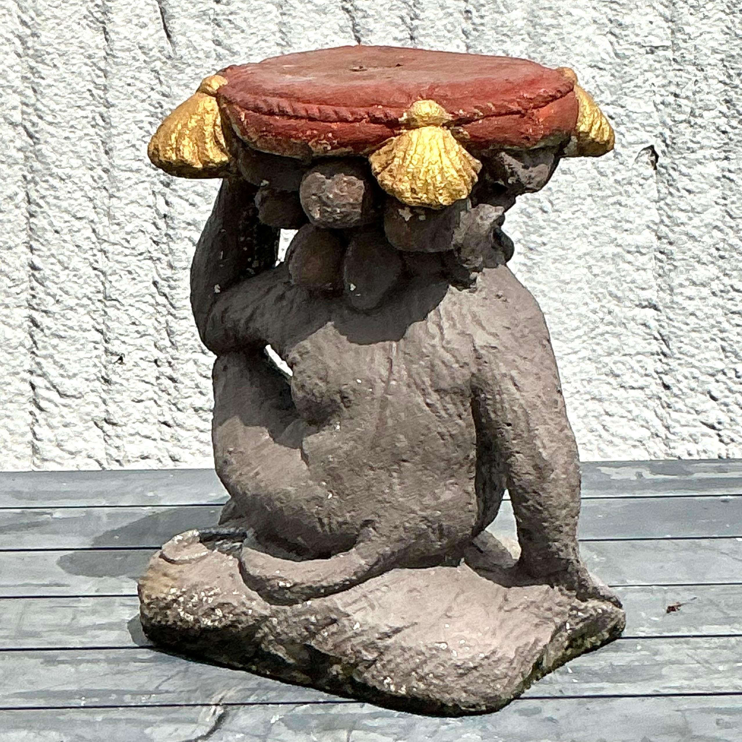 Add a playful and artistic element to your space with this vintage boho cast concrete monkey low stool. Expertly crafted with detailed features and a sturdy build, this unique stool blends functionality with bohemian charm. Perfect for adding a