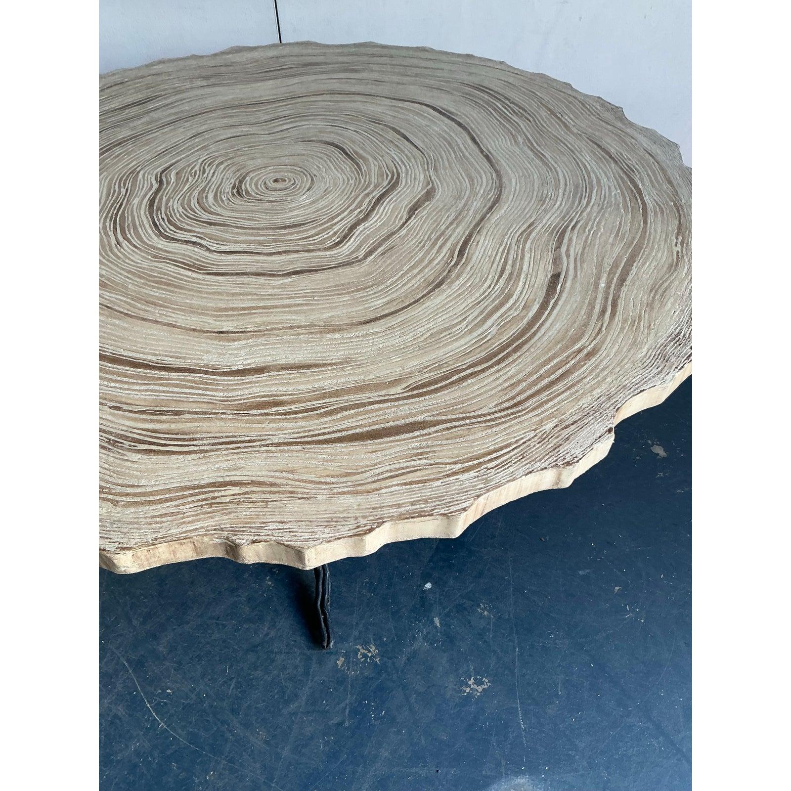 This exceptional vintage coffee table masterfully blends natural aesthetics with robust craftsmanship, presenting a striking cast concrete top meticulously designed to mimic the intricate rings of a tree slab. Evoking a warm, organic, and