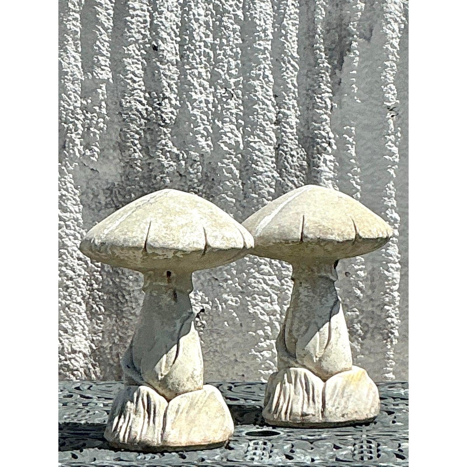 Add a whimsical, nature-inspired touch to your space with this charming pair of vintage cast stone mushroom sculptures. These beautifully aged garden accents feature an organic, sculptural design, capturing the enchanting essence of bohemian and