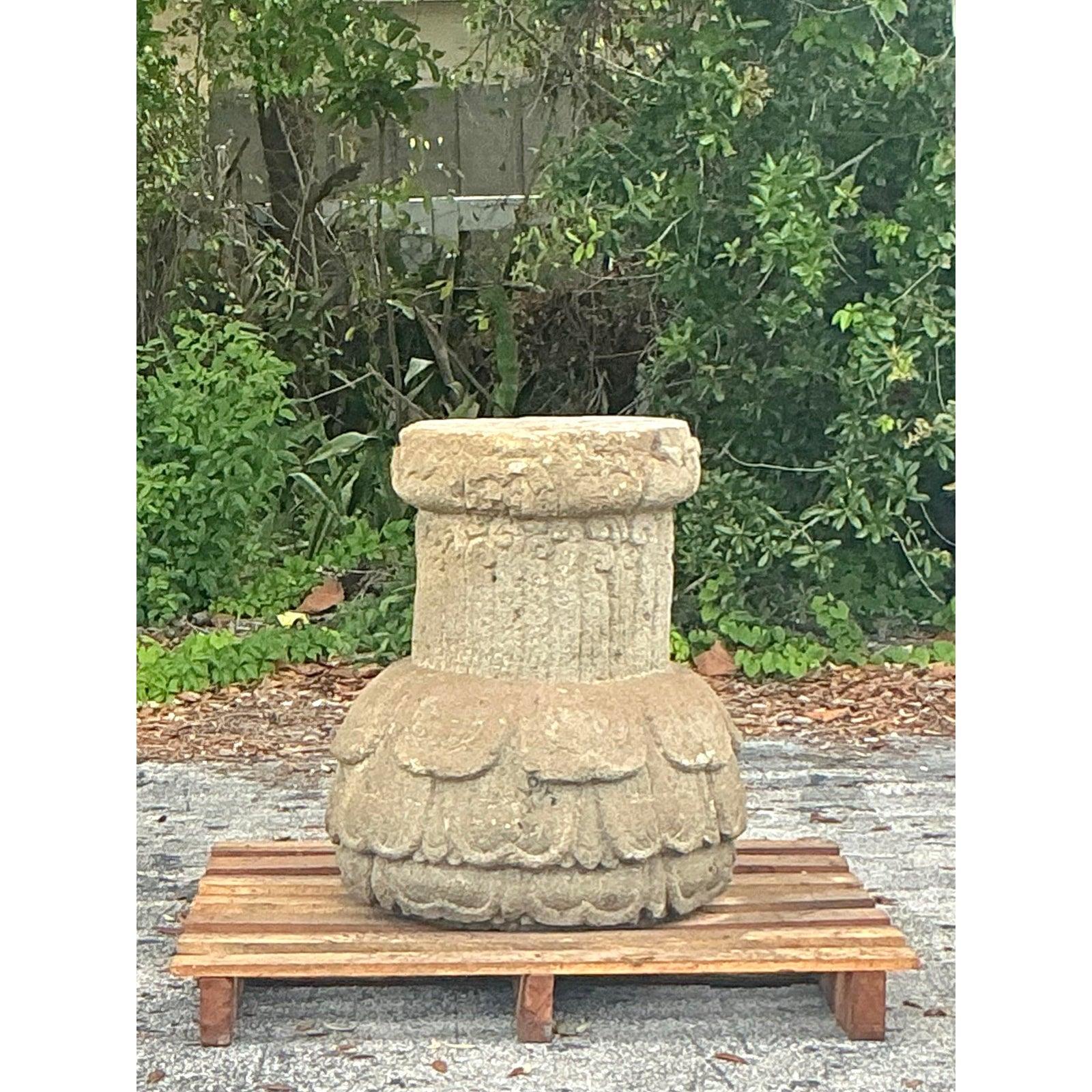 Embrace a touch of timeless character and robust artistry with this captivating vintage cast stone pedestal. Its unique design features a sturdy, fluted column rising from a wonderfully detailed bulbous base, adorned with carved, oversized petal or