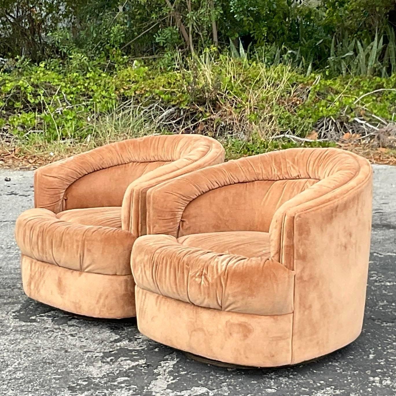 An exceptional pair of vintage Boho swivel chairs. Beautiful channel tufted velvet in a gorgeous caramel color. Done in the manner of Thayer Coggin. Acquired from a Palm Beach estate.