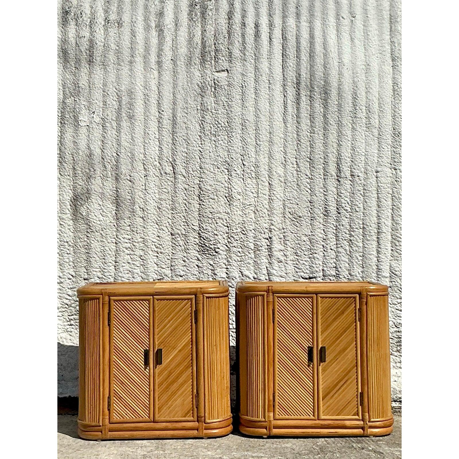 Add a touch of bohemian elegance to your space with this stunning pair of vintage chevron reed nightstands. Featuring a striking handwoven chevron pattern on the doors, these pieces exude natural charm and organic texture. The rounded edges and warm