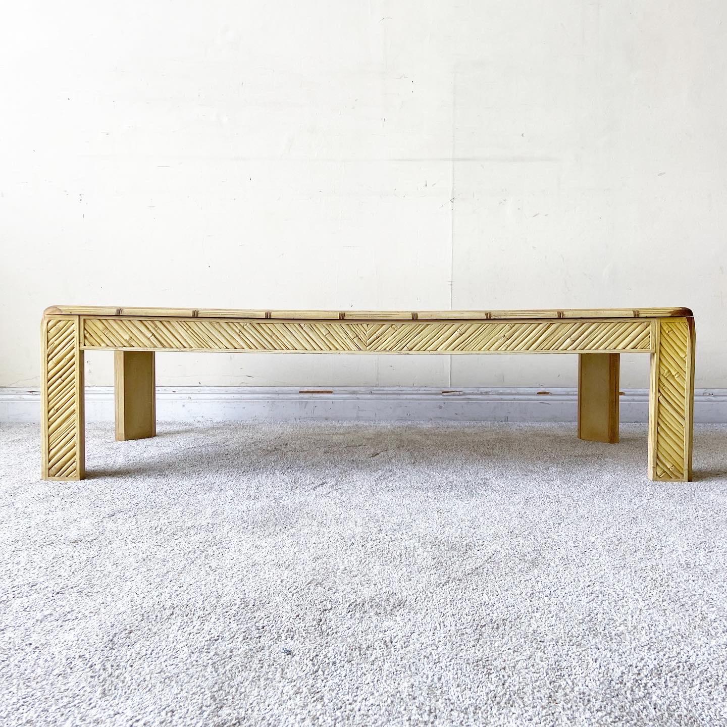 Amazing vintage palm beach boho chic rectangular coffee table. Features a glass top with a faux bamboo frame with distressed edges.