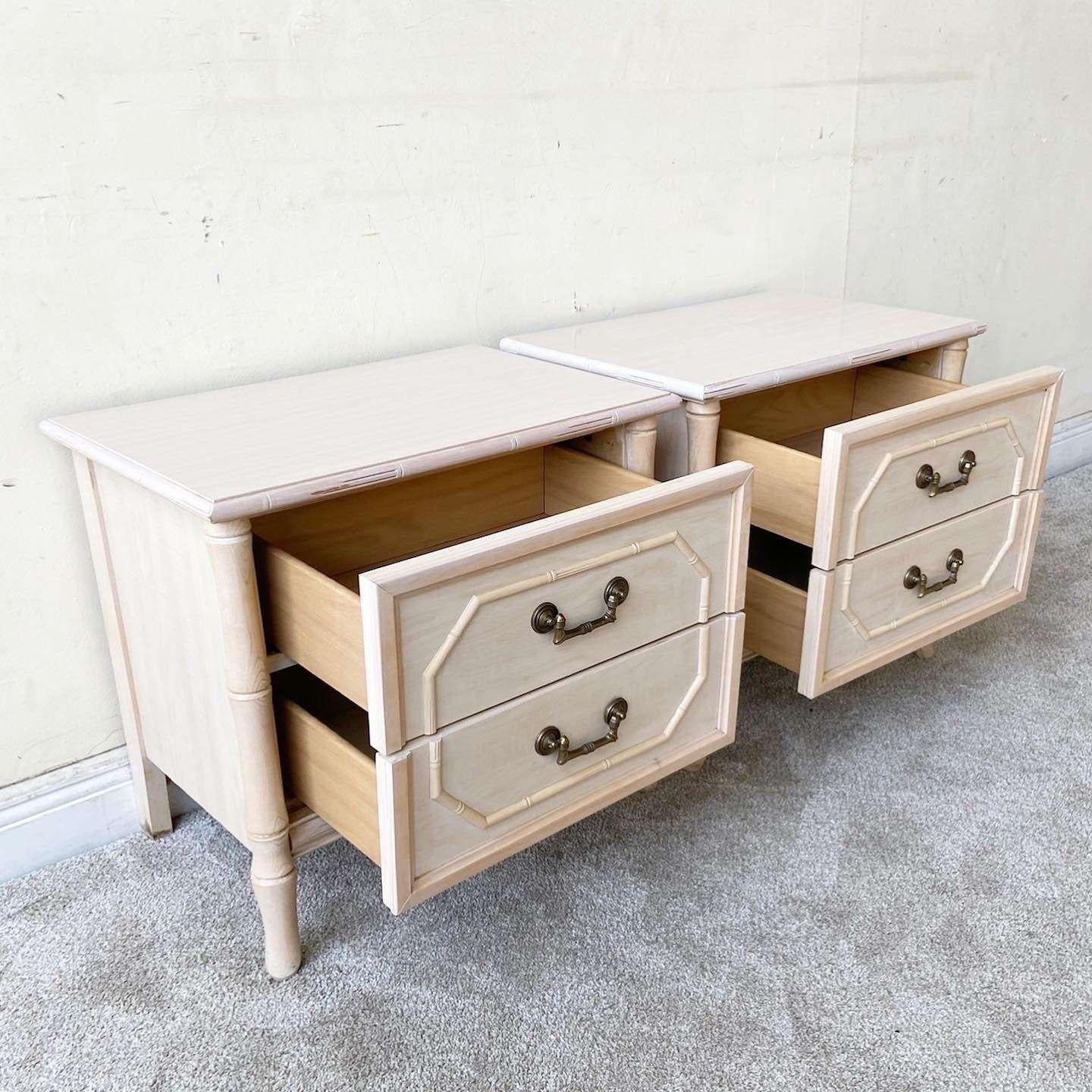 Amazing pair of vintage bohemian nightstands by Broyhill. Each feature a fantastic faux bamboo frame with a washed finish and 2 spacious drawers.