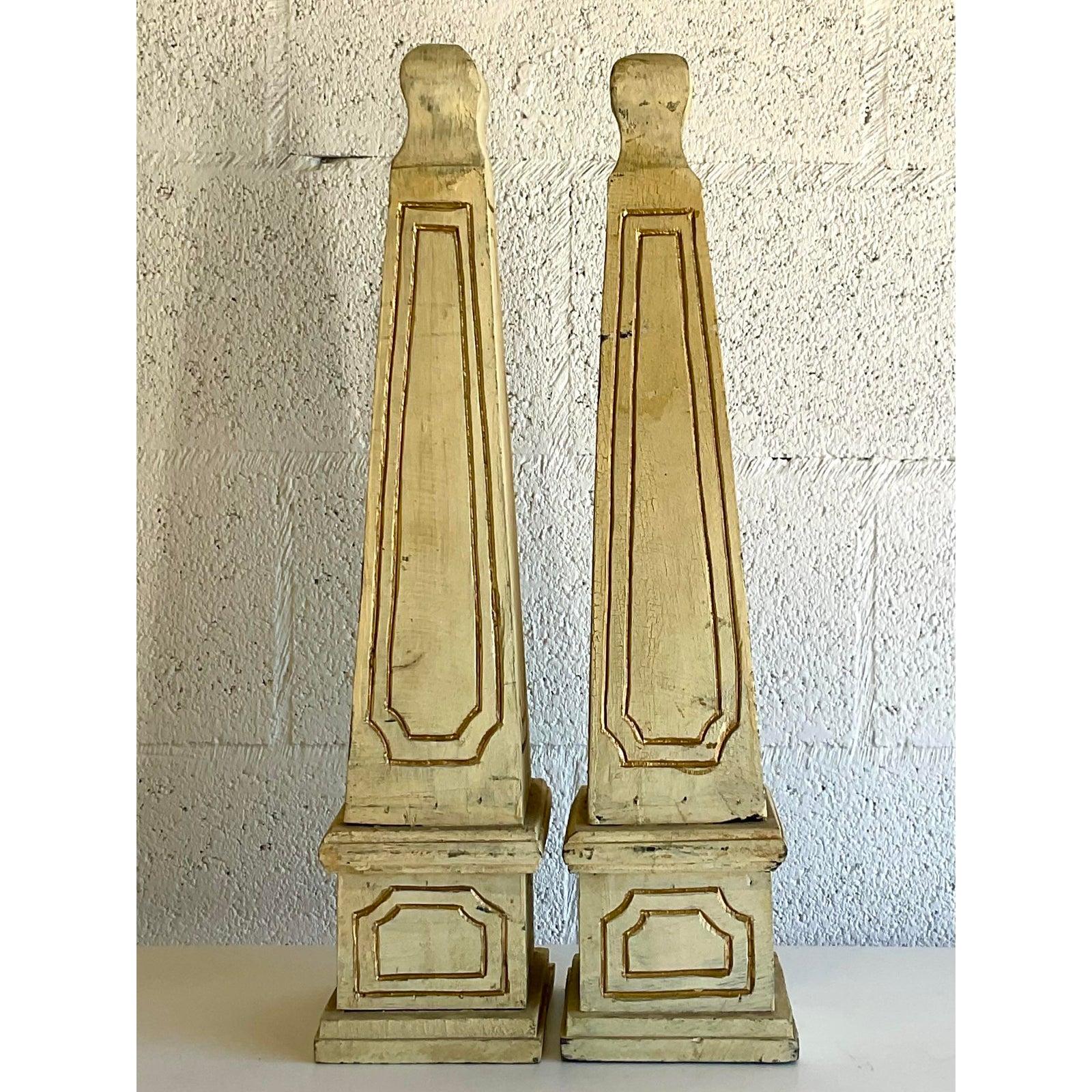 A fantastic pair of Boho Chic obelisks. Hand carved detail on solid wood construction. Gilt detail on the routed lines. An artisan approach to an iconic Regency staple of design. Acquired from a Palm Beach estate.