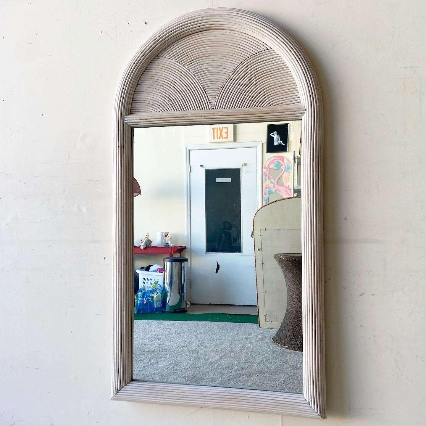 Incredible vintage bohemian wall mirror. Features a washed pencil reed frame.