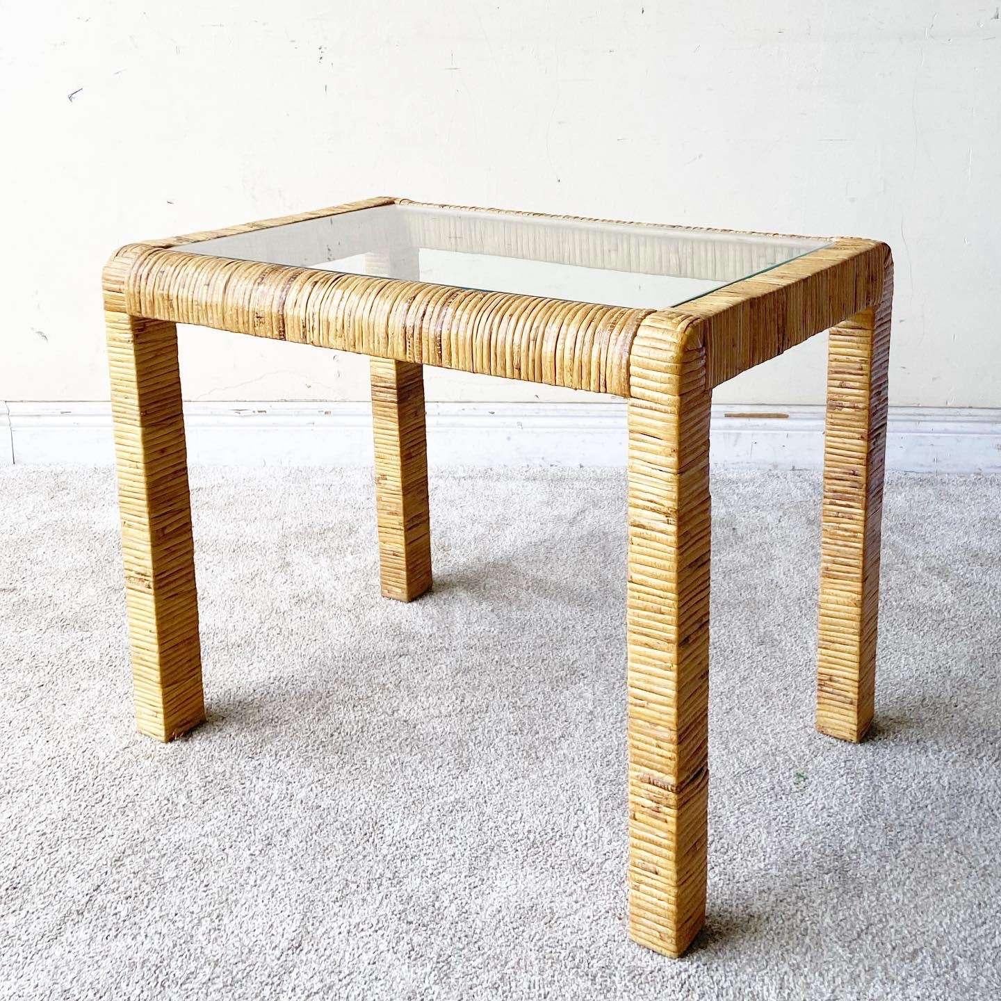 Incredible vintage bohemian glass top side table. Features a fantastic rattan wrapped rectangular frame.