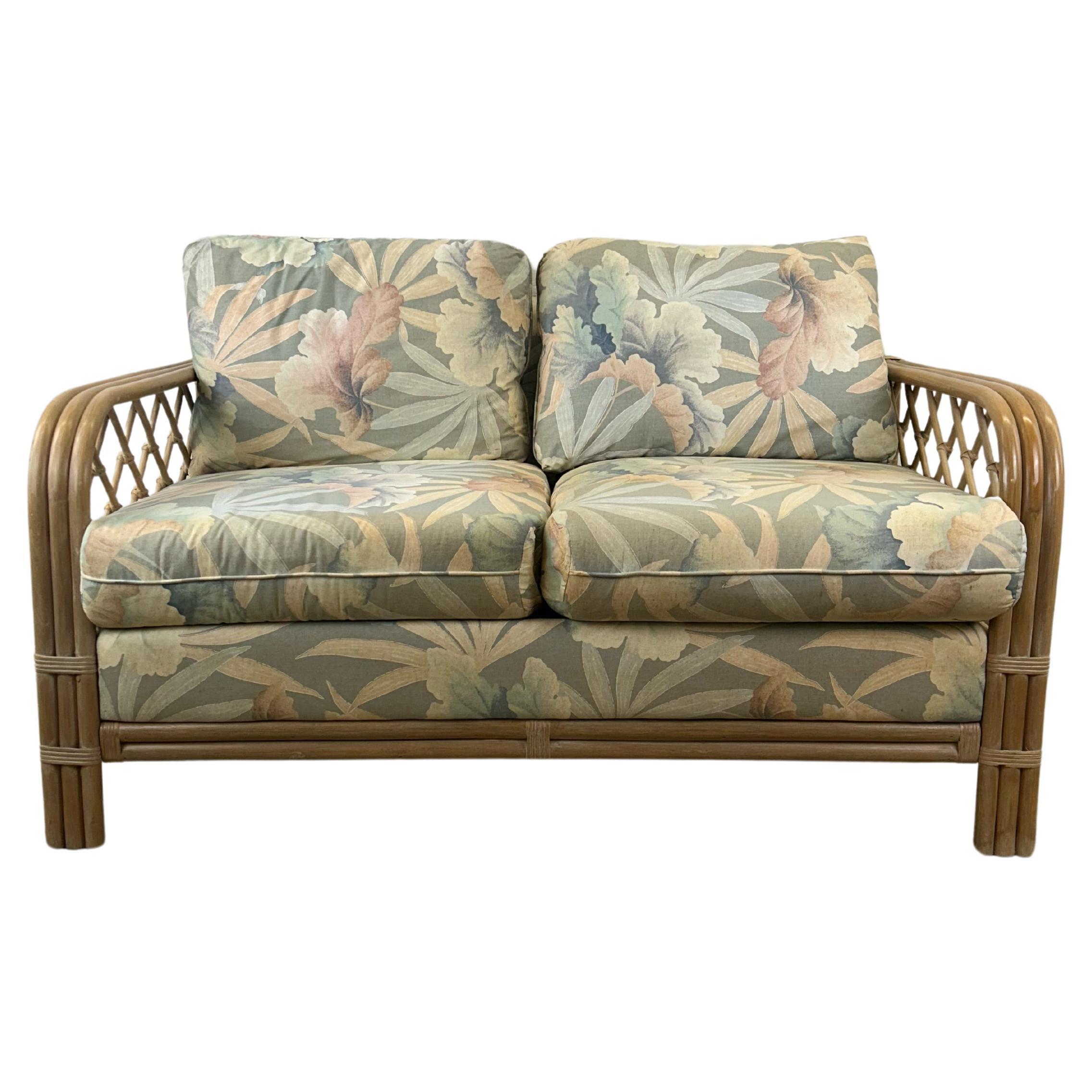 Vintage Boho Chic Rattan Loveseat with Floral Upholstery For Sale