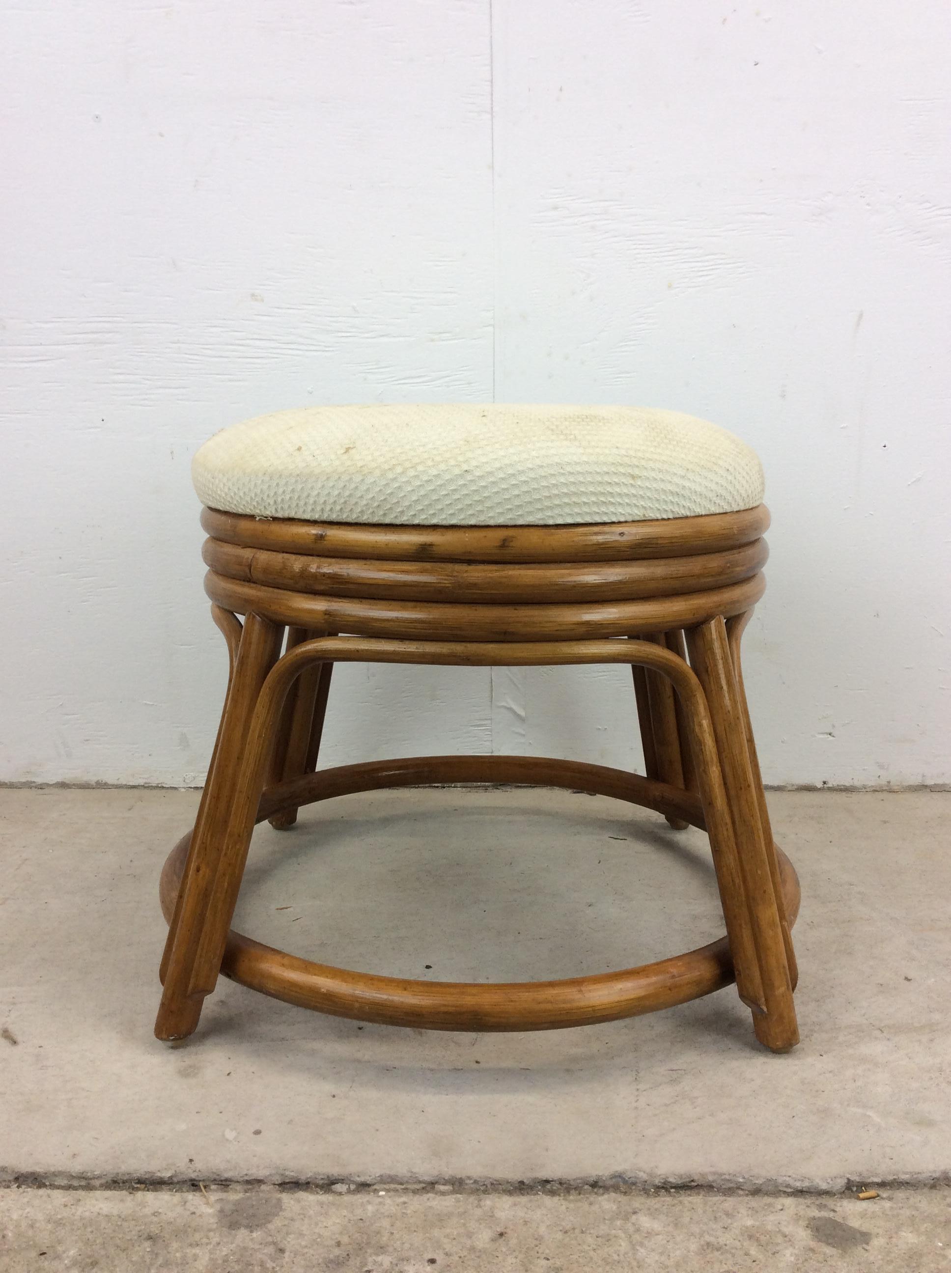 This vintage ottoman footstool features curved rattan frame and upholstered top with vintage fabric.

Please check out our other rattan listings!

Dimensions: 19w 19d 17h

Condition: Rattan frame has some scuffs, scratches, and kick marks.  There is