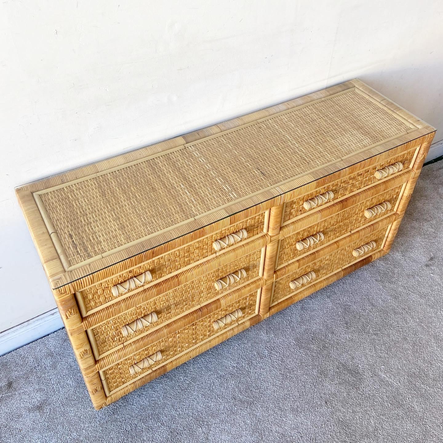 Excellent vintage bohemian dresser with a glass top. Features a rattan frame and wicker panels throughout.
 