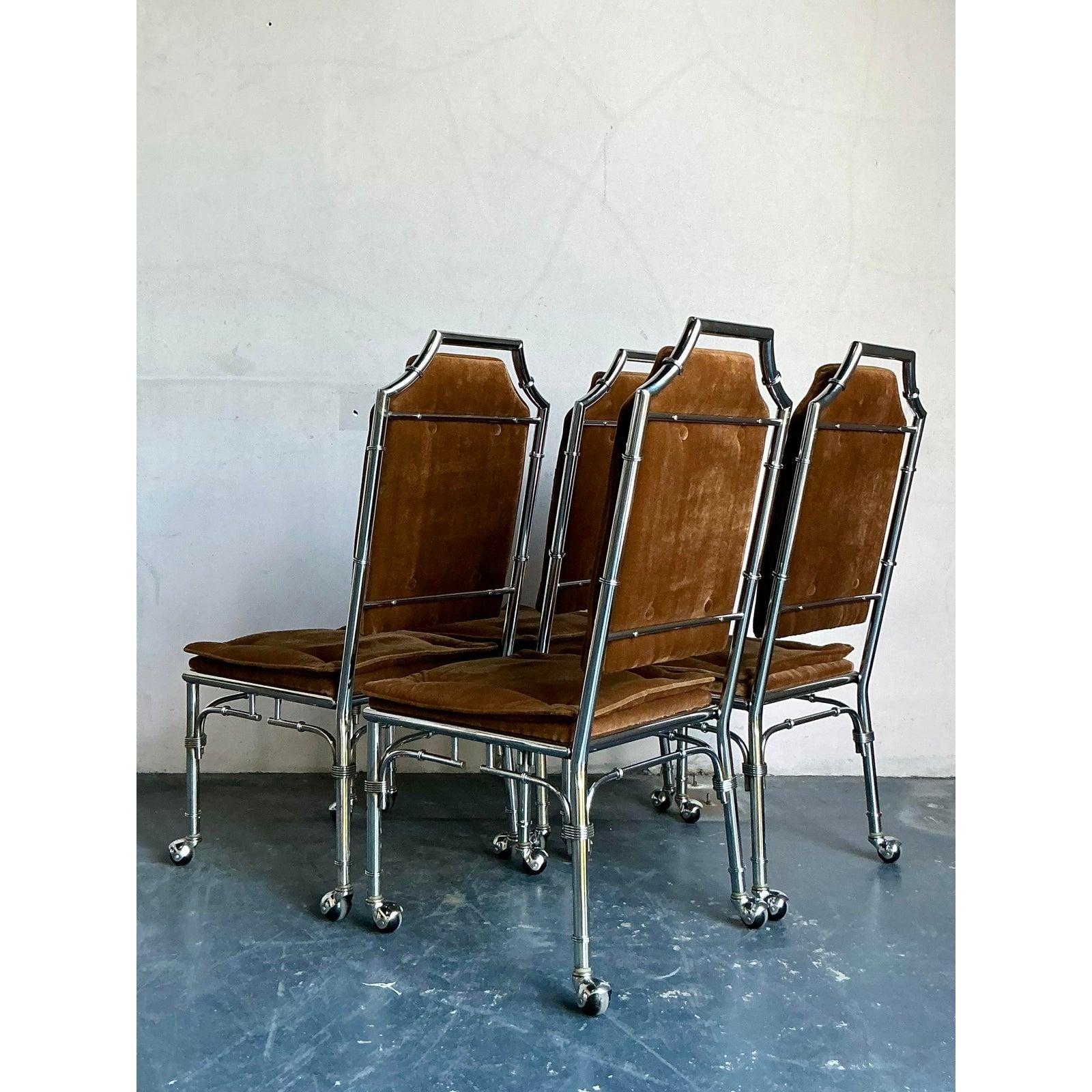 This sensational set of four dining chairs perfectly captures the high-octane glamour of the Hollywood Regency era, blending reflective materials with luxurious, tactile upholstery. Each chair features a sleek chrome-plated frame meticulously