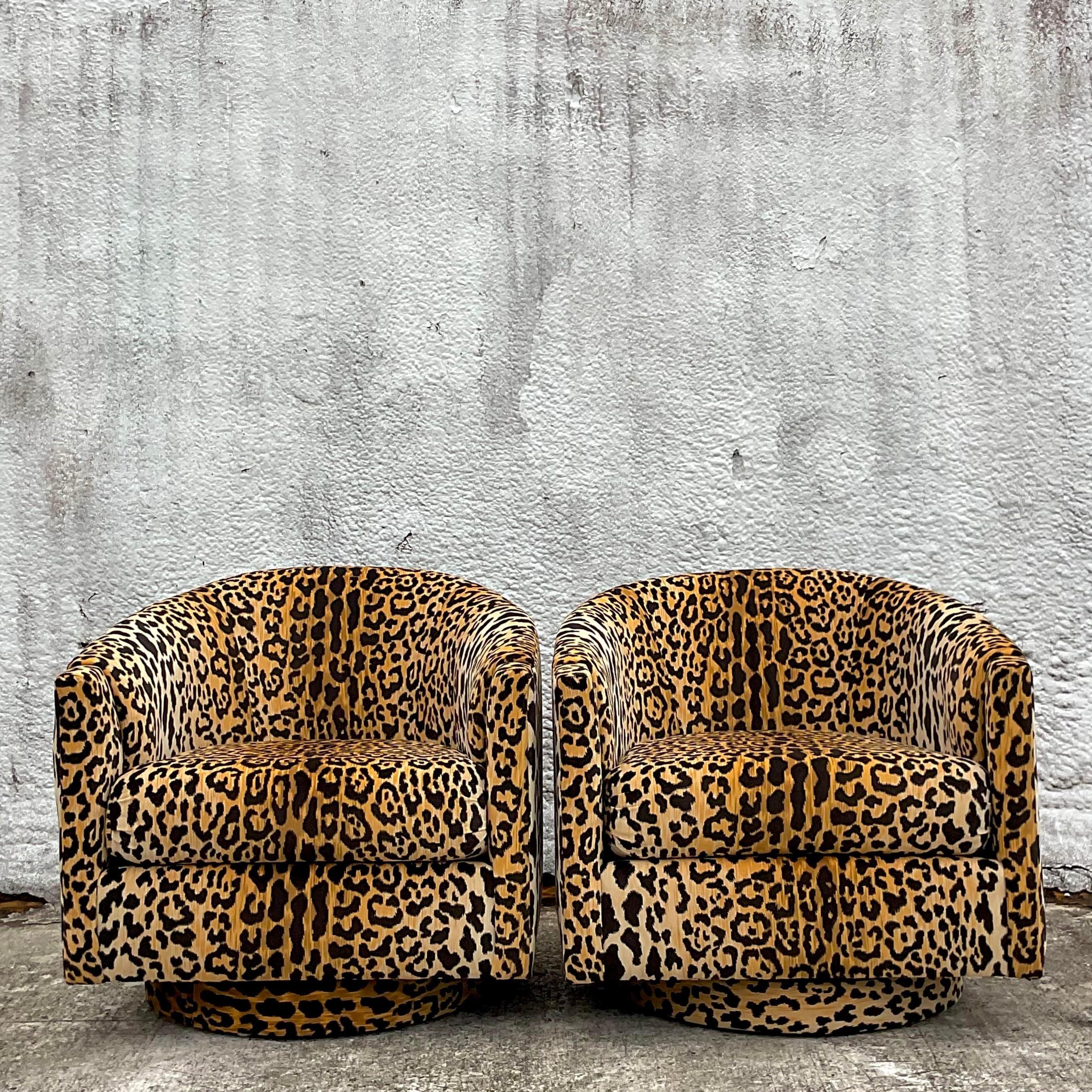 An insanely fabulous pair of vintage swivel chairs. Gorgeous Clarence House “Samburu” velvet leopard in pristine condition. Wide upholstered wooden plinth on the bottom. Acquired from a Palm Beach estate