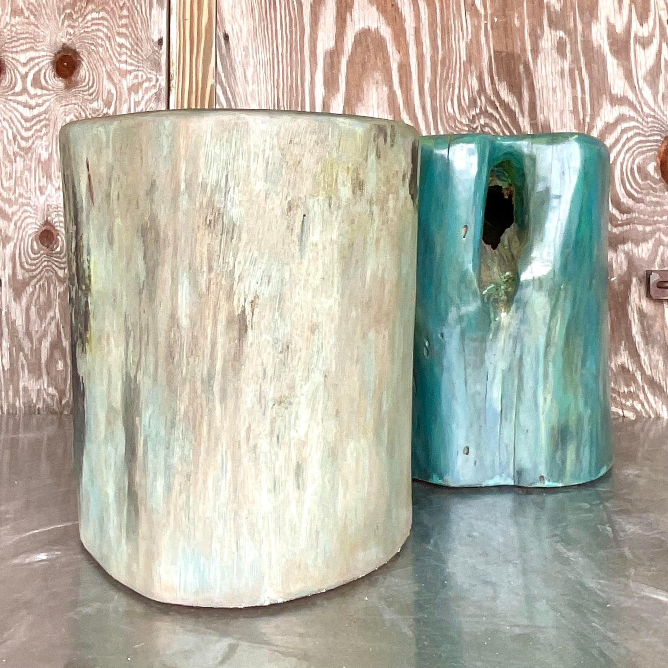 A stunning set of two vintage Boho low stools. A chic blue green color wash on two organic tree stump stools. Solid wood make them perfect as seating, drink tables or pedestals. You decide! Acquired from a Palm Beach estate.

Smaller stools