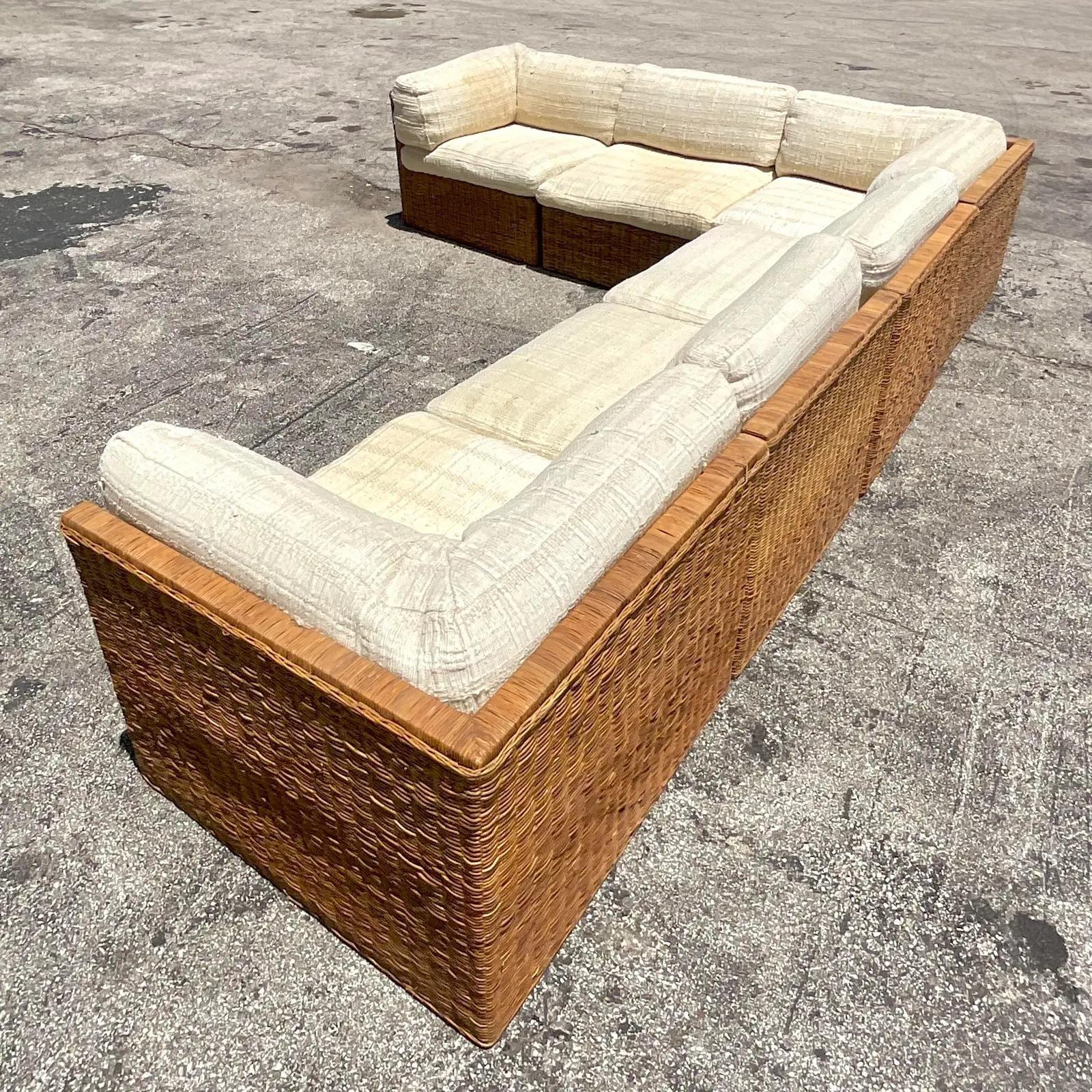 An exceptional vintage Boho sectional sofa. A chic woven rattan with six individual sections. Rearrange the sections to suit your project needs. A heavy cotton boucle with a textured design. Made by the Comfort Designs group and tagged on the