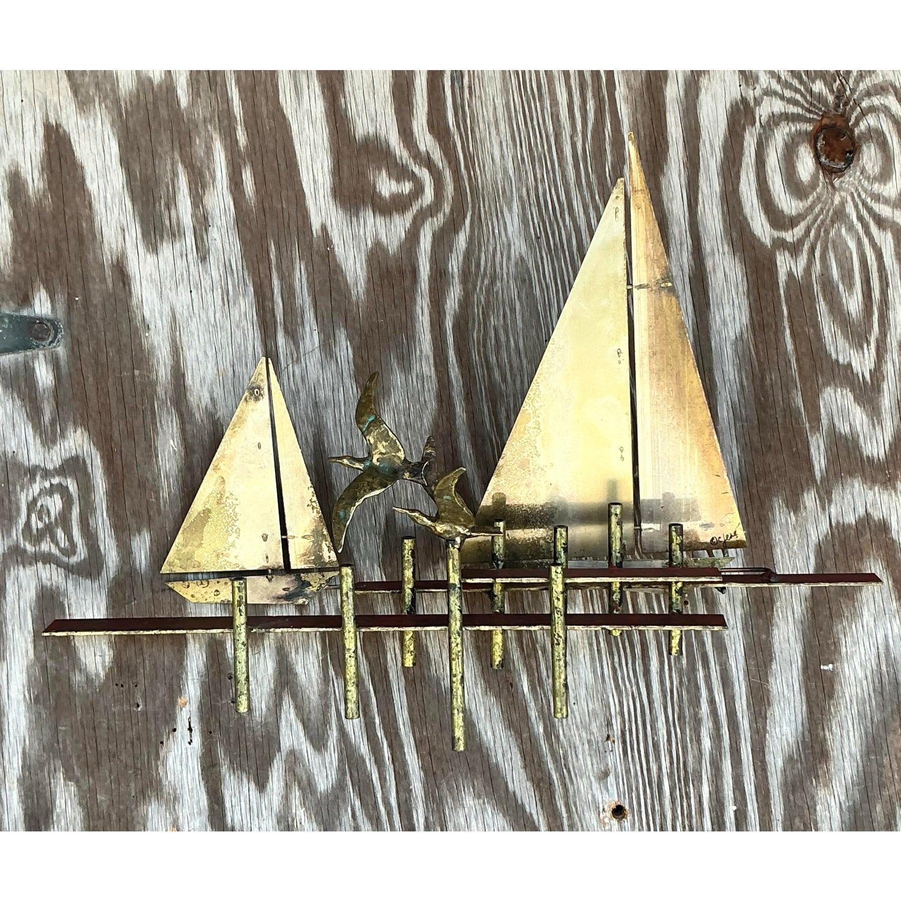 Elevate your interior with this stunning vintage Curtis Jere sailboat wall sculpture, a true masterpiece of mid-century modern artistry. This handcrafted piece showcases intricate sailboat details, complete with a dynamic portrayal of seagulls in
