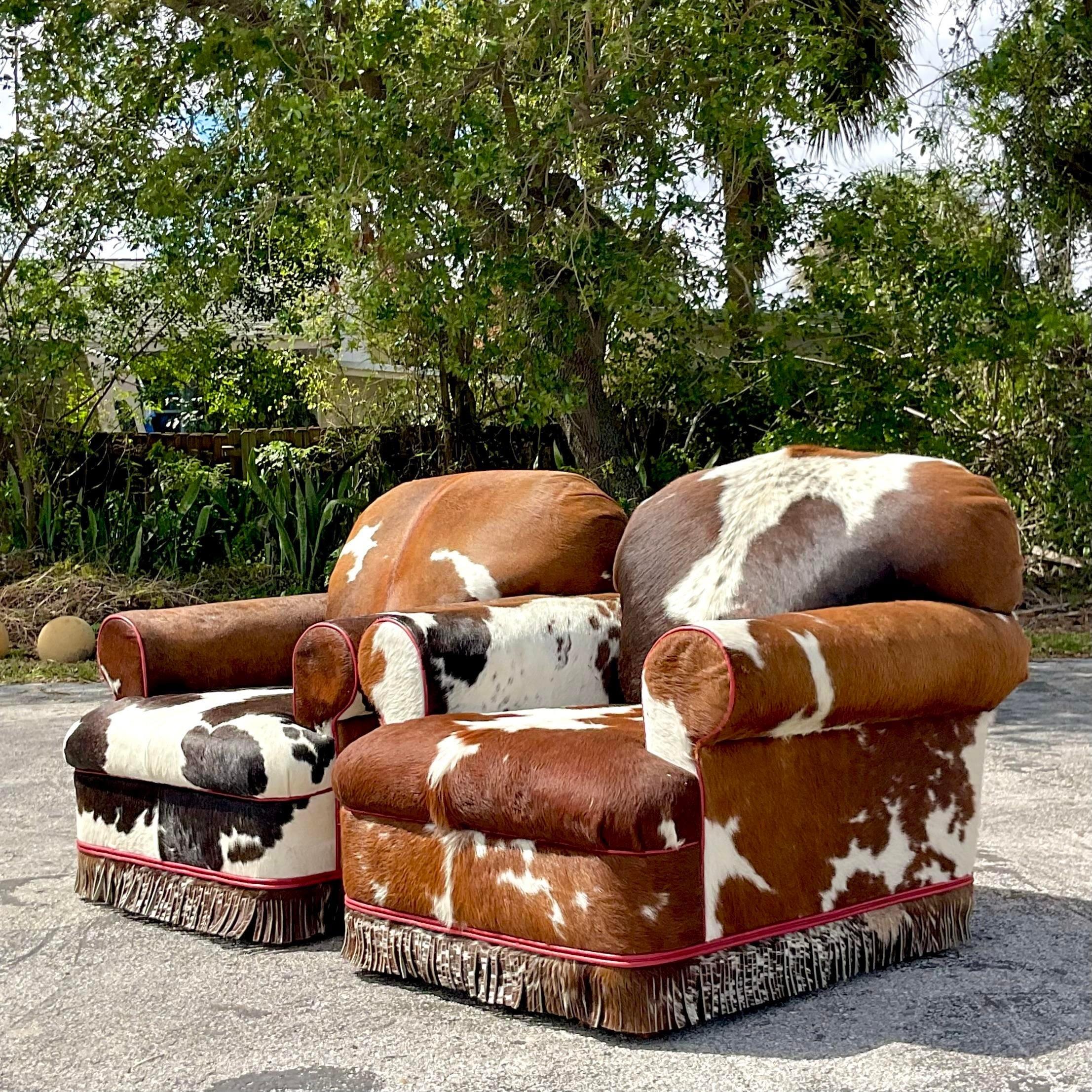 Elevate your living space with this one-of-a-kind pair of Vintage Boho Custom Cowhide Lounge Chairs. Crafted for comfort and style, these chairs blend bohemian flair with rustic charm, featuring luxurious cowhide upholstery that adds a touch of