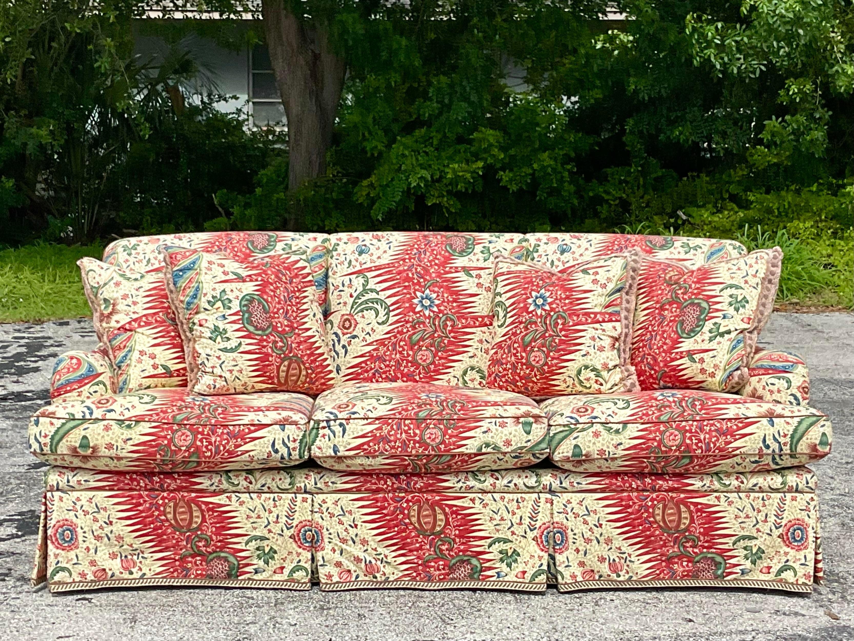 A spectacular vintage Boho custom down sofa. Upholstered in the extraordinary Pierre Frey’s “La Rivière Enchantee” fabric. Beautiful solid construction with a roll back and box pleat skirt. Lots of amazing trims and fringe to complete the look.