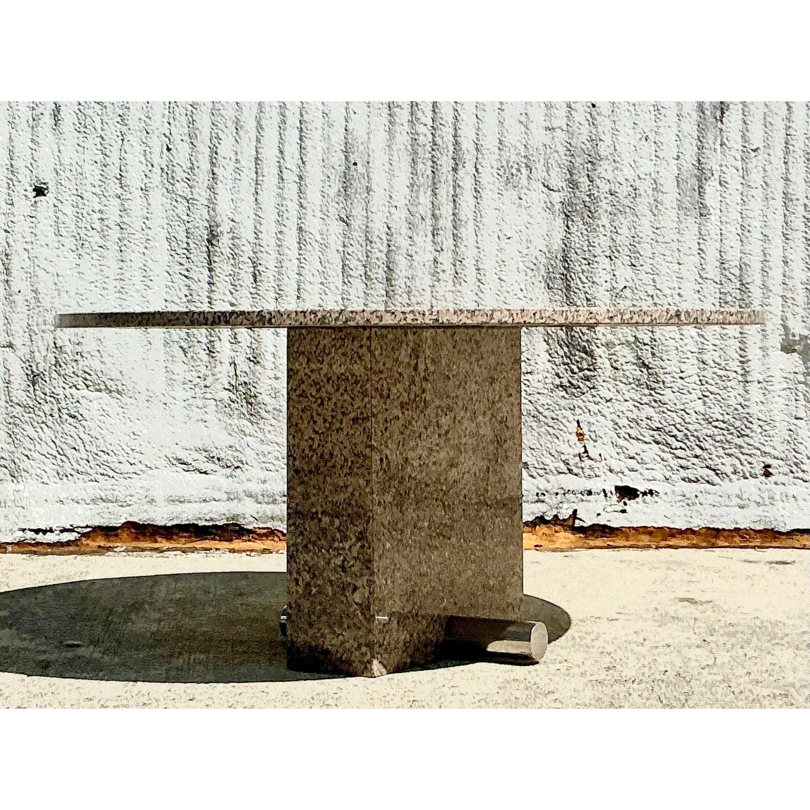 Make a bold statement with this vintage custom granite dining table, a luxurious piece that merges natural beauty with modernist design. The striking 60-inch round granite tabletop showcases an elegant blend of warm earth tones with intricate