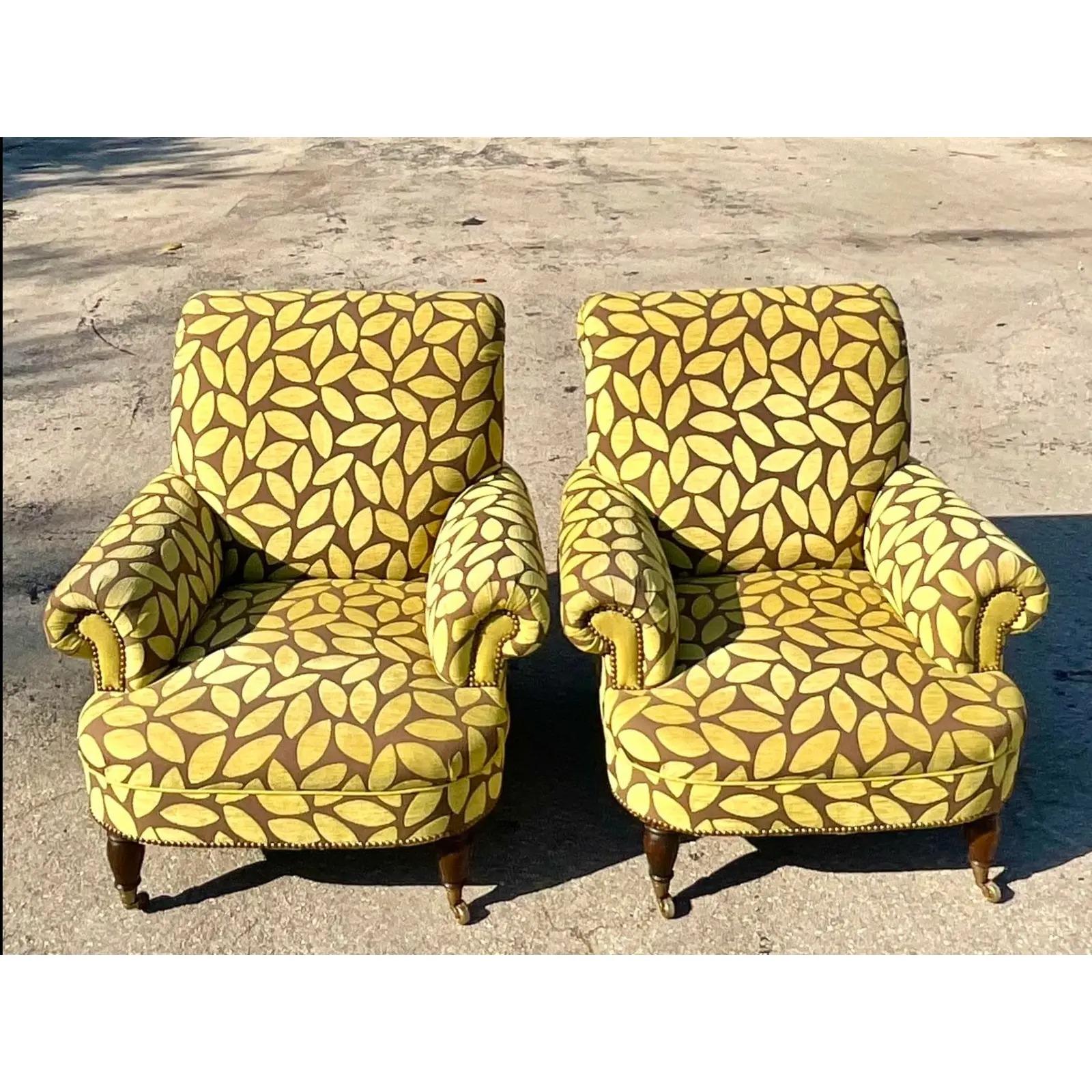 Fantastic pair of vintage boho lounge chairs. Beautiful cut velvet in a floating leaf design. A classic roll arm shape with turned legs on casters. Acquired from a Palm Beach estate.