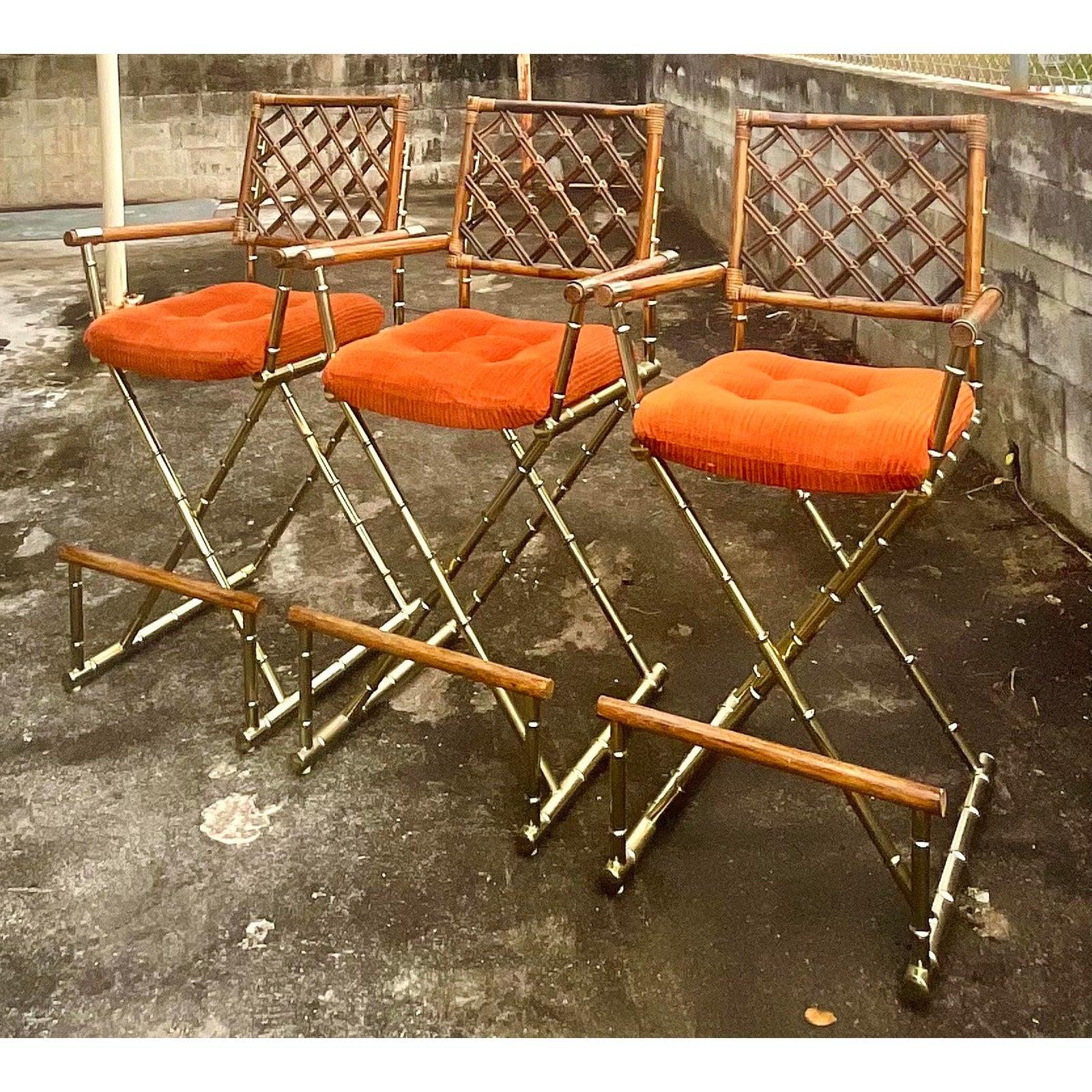 Fantastic set of three vintage boho barstools. Made by the Daystrom group in the US. Brass bamboo frame with a rattan trellis back. Foot rest at the bottom for maximum comfort. Acquired from a Miami estate.