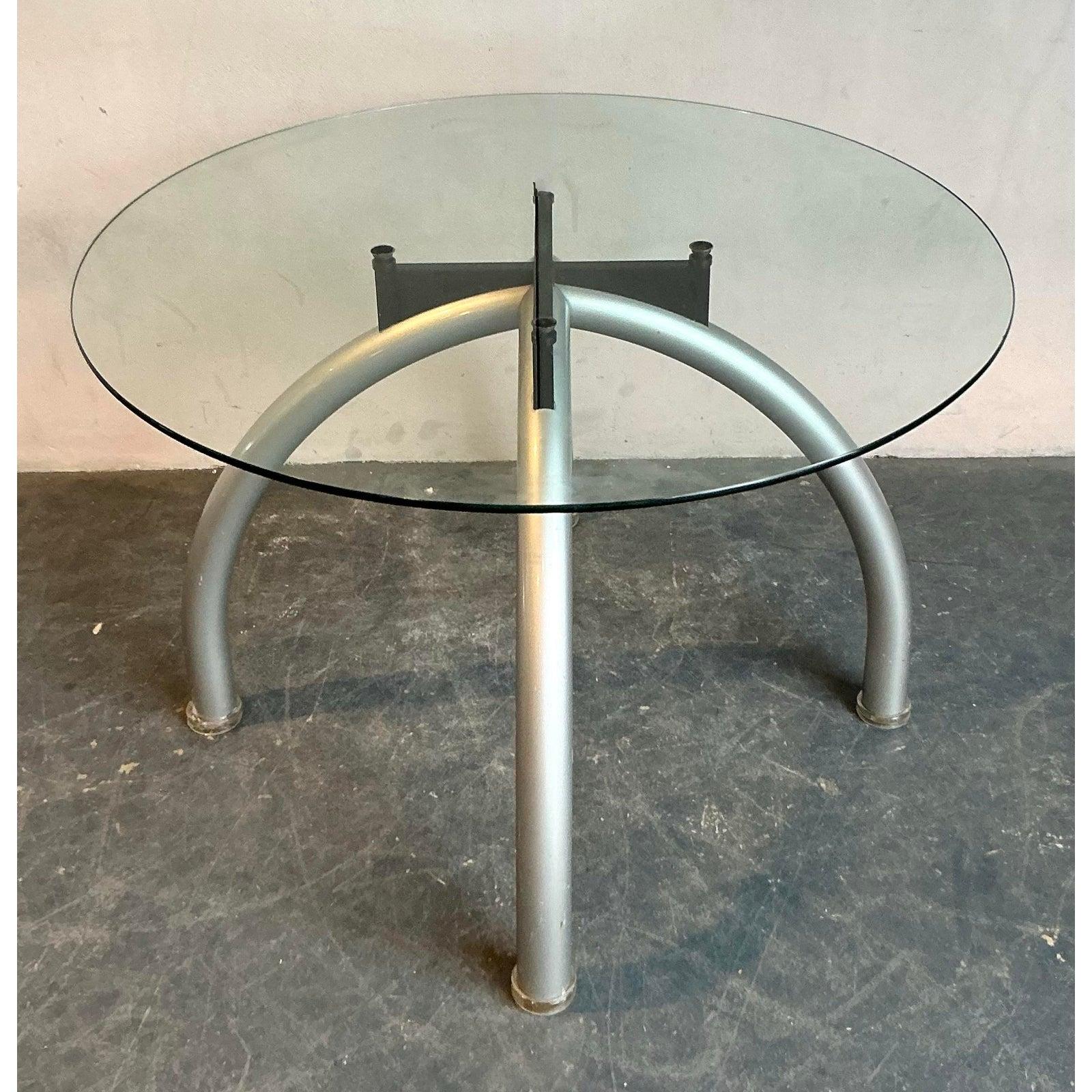 Inject a dose of postmodern cool into your dining space with this fantastic vintage dining table, created in the spirit of the iconic Ettore Sottsass and the Memphis Group. This piece features a striking and playful design, with a clear glass top